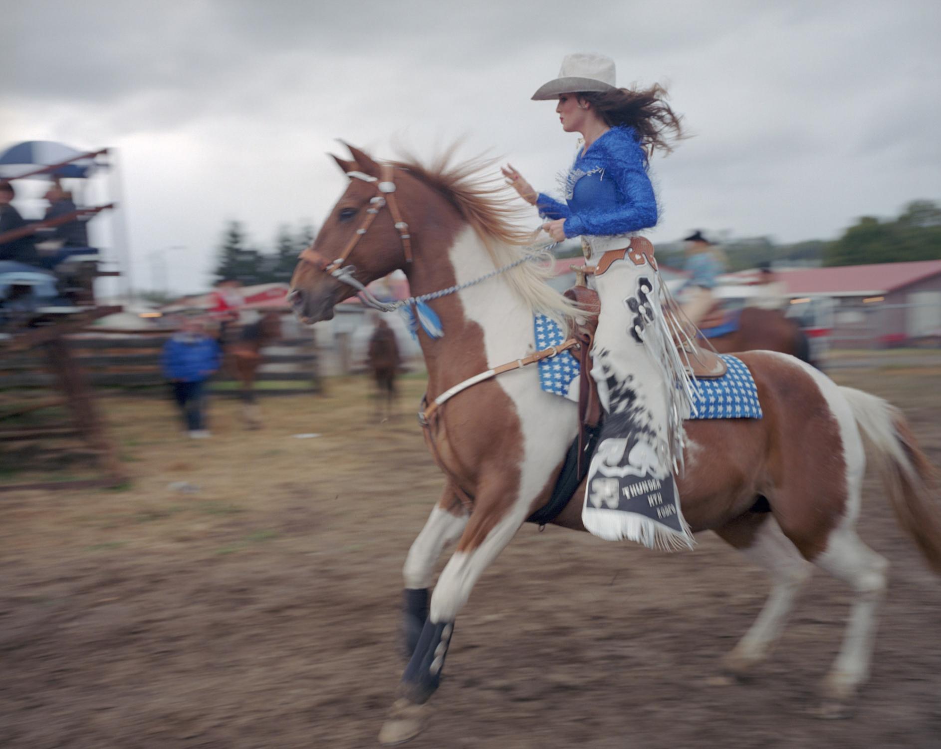 American Moments - Thunder Mountain Pro Rodeo Queen Jessica West riding her...