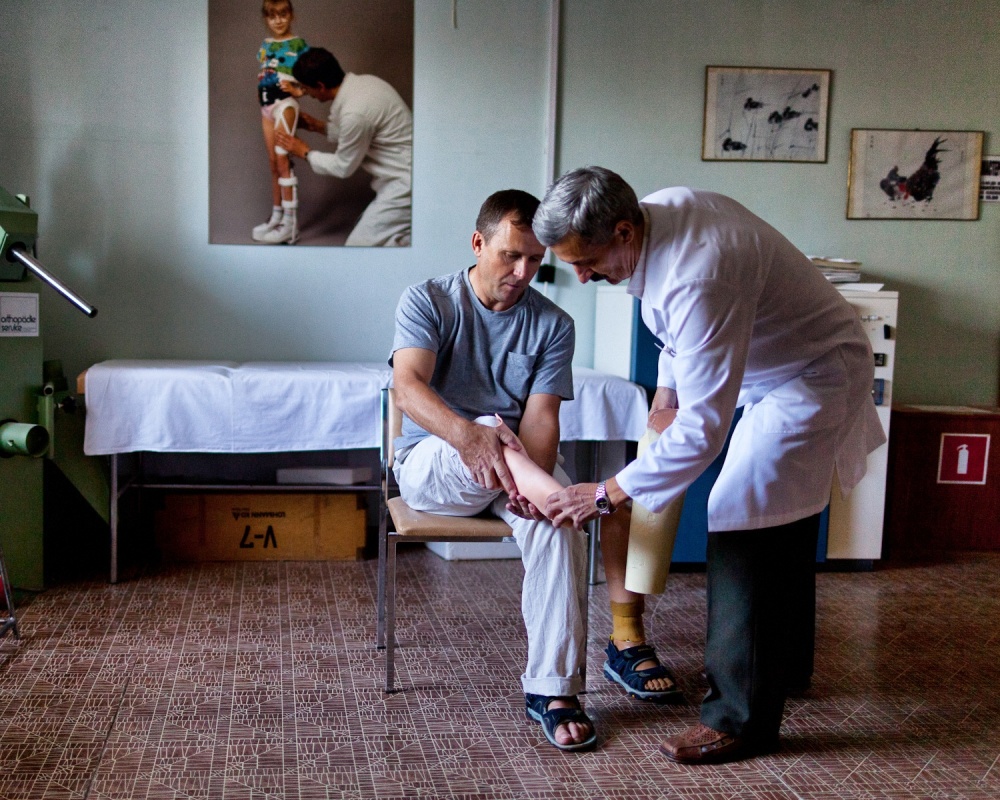Vitaly Merkulov, a prosthetist,... a refitting of his prosthetic.
