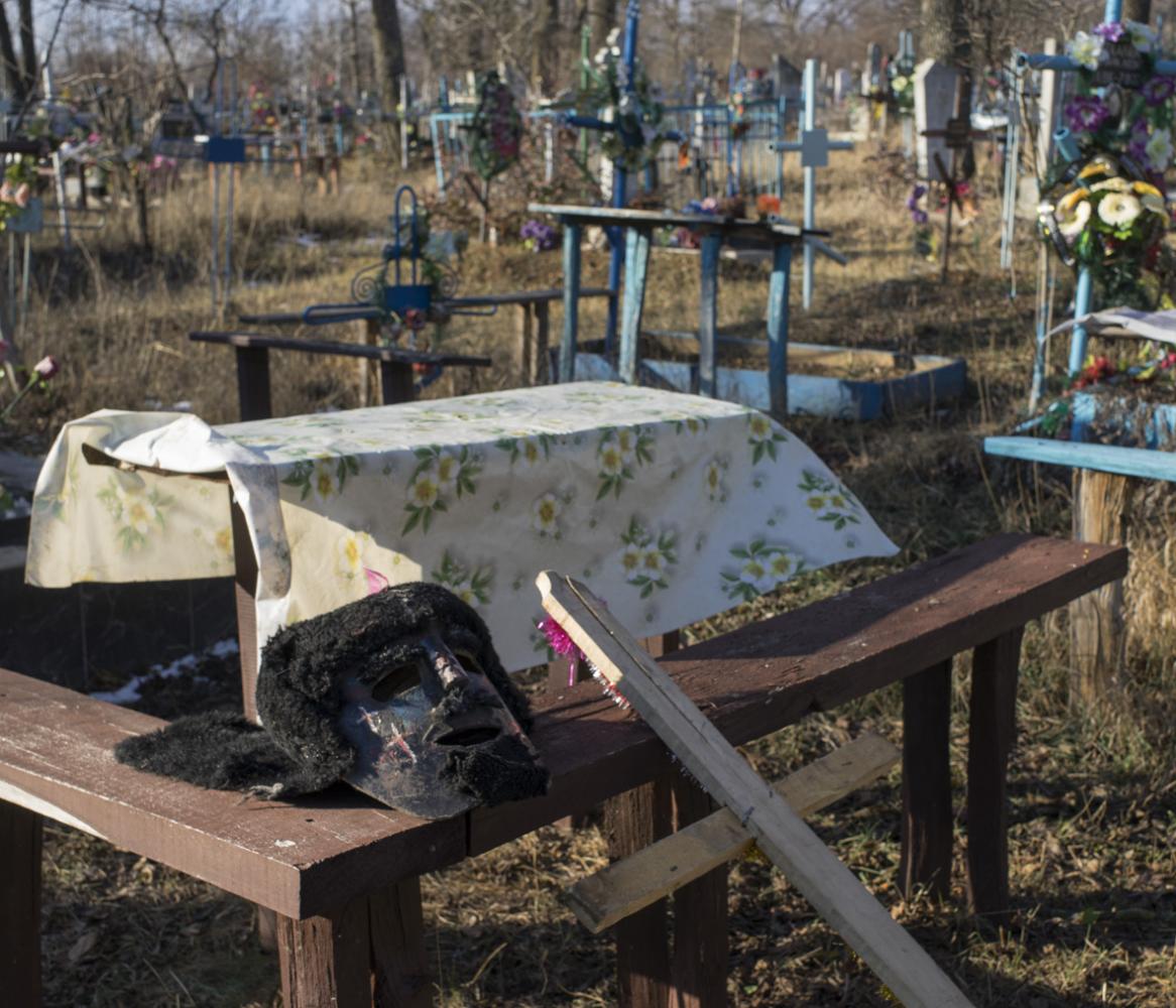Image from Malanca in Palanca - A mask is lying on a bench in the cemetery while the...