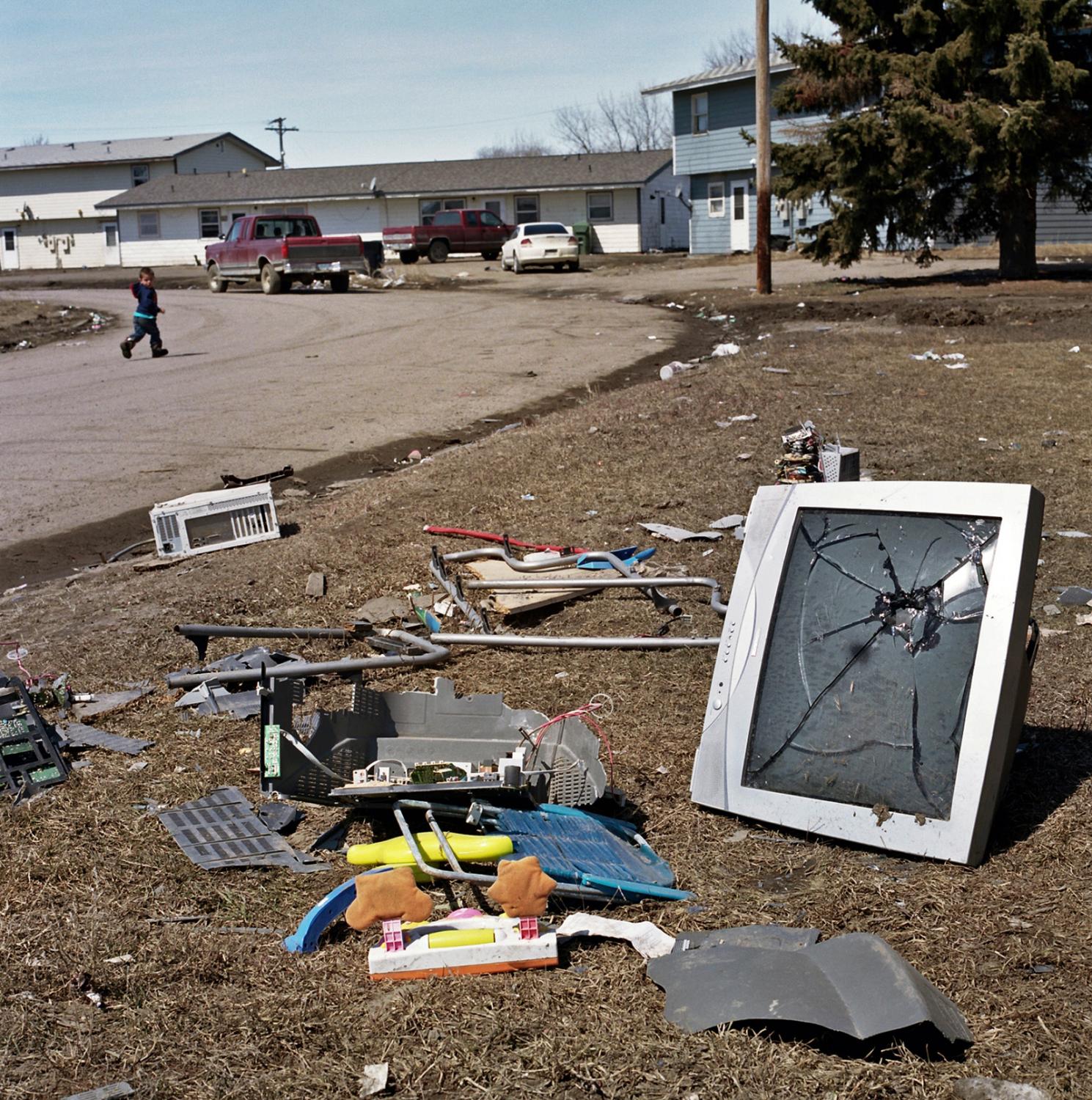 Spirit Lake - Broken TV set thrown out to the front yard of a home in...