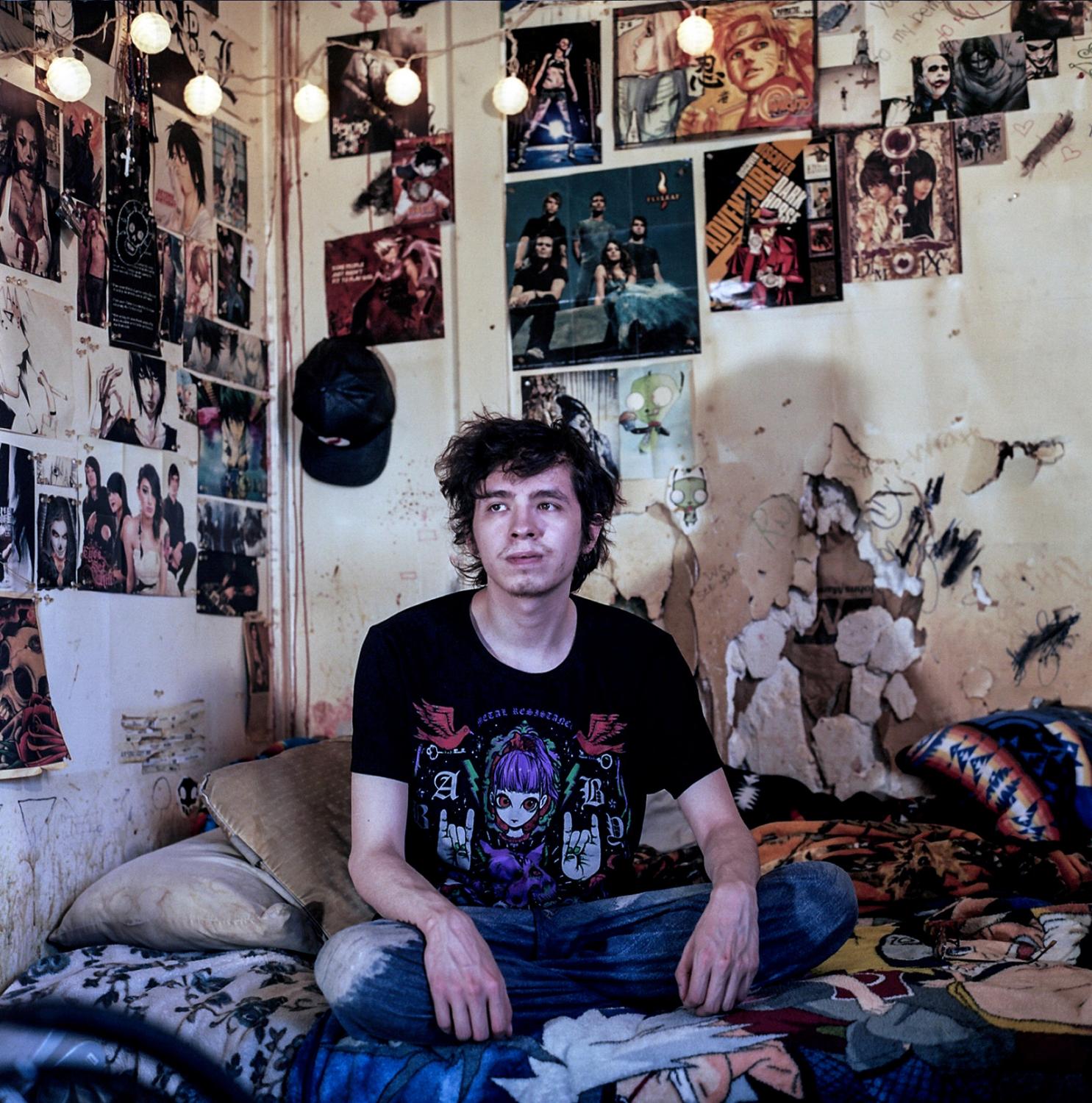 Spirit Lake - Brennan at home in his room surrounded by the posters of...