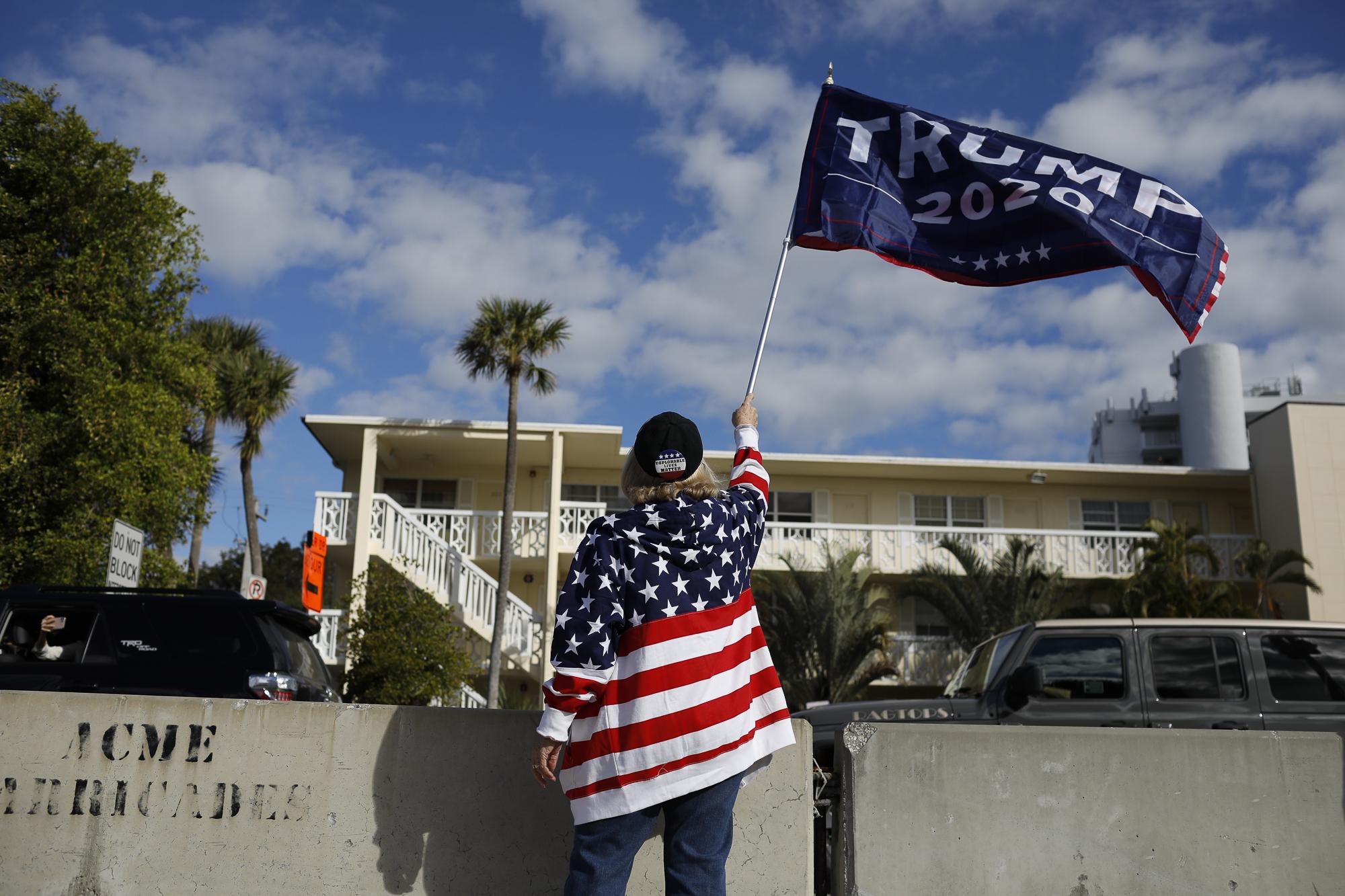 Supporters of President Donald Trump stand near the road as he arrives in West Palm Beach, Florida, U.S., January 20, 2021. REUTERS/Marco Bello