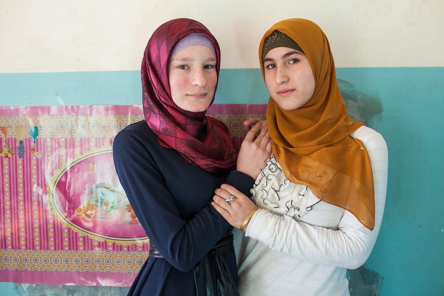 Chechen girls posing for photo at public School. Many families cannot afford to send their...