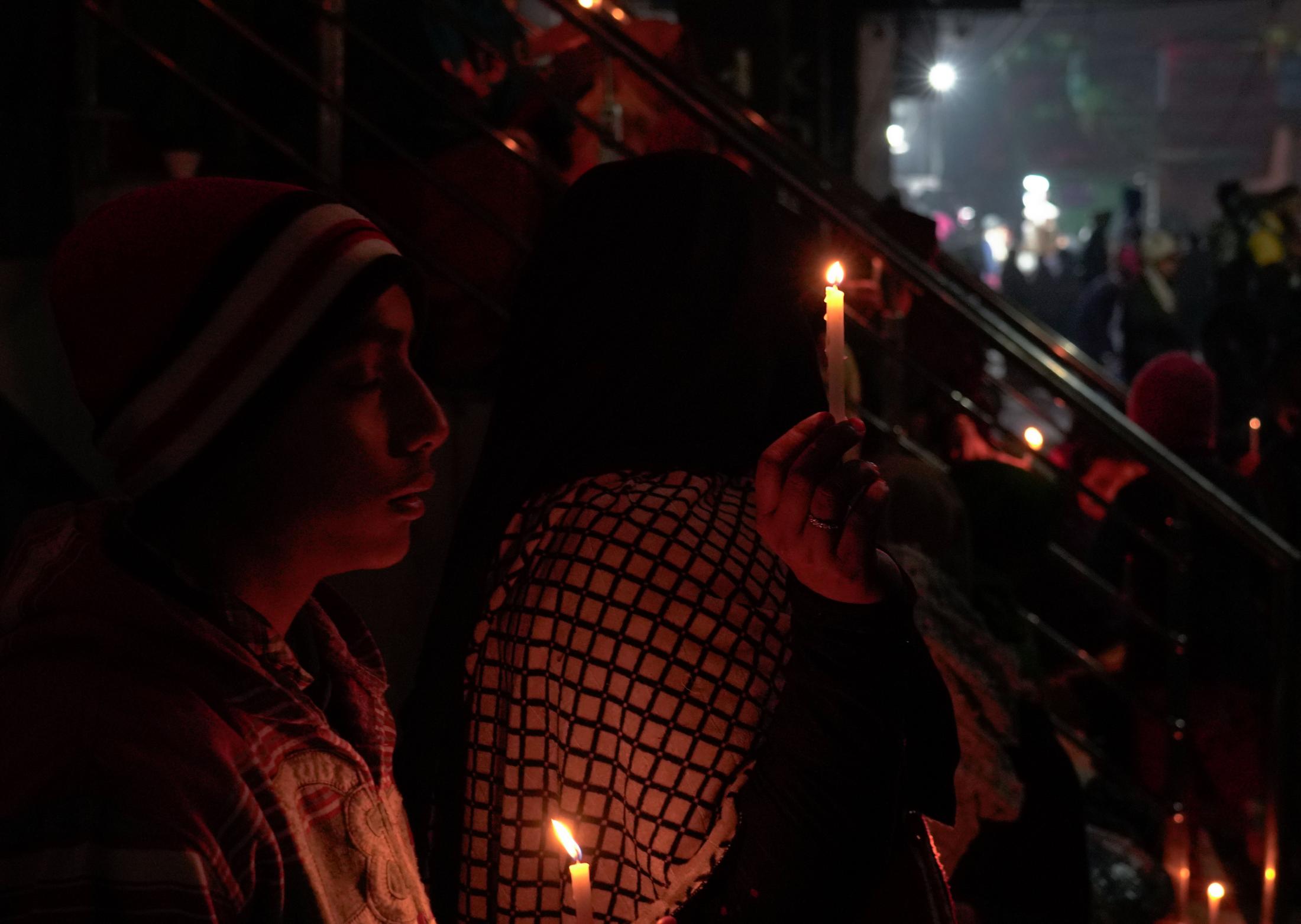 Aazadi - Anti-CAA protesters hold candles during a vigil at...