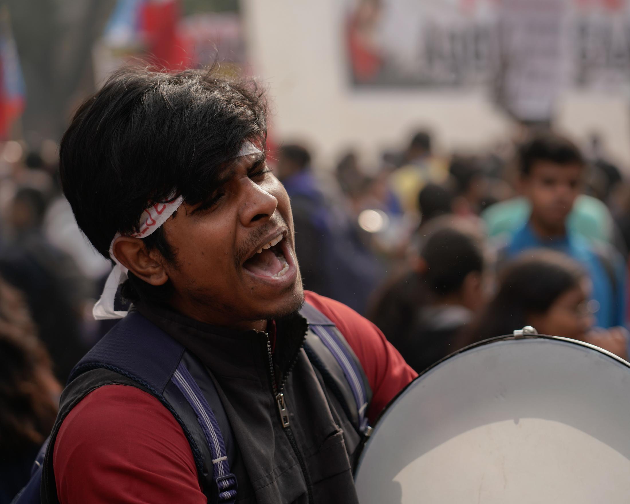 Aazadi - An anti-CAA protester beats a drum during a chant at...