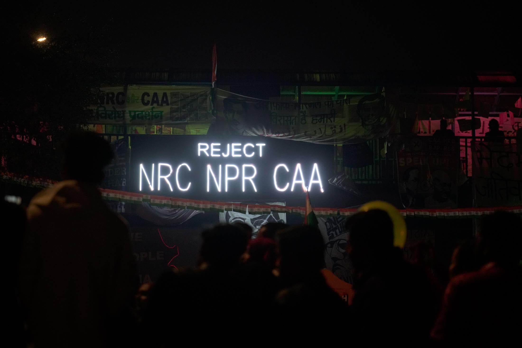 Aazadi - A sign illuminated with the slogan, "Reject NRC,...