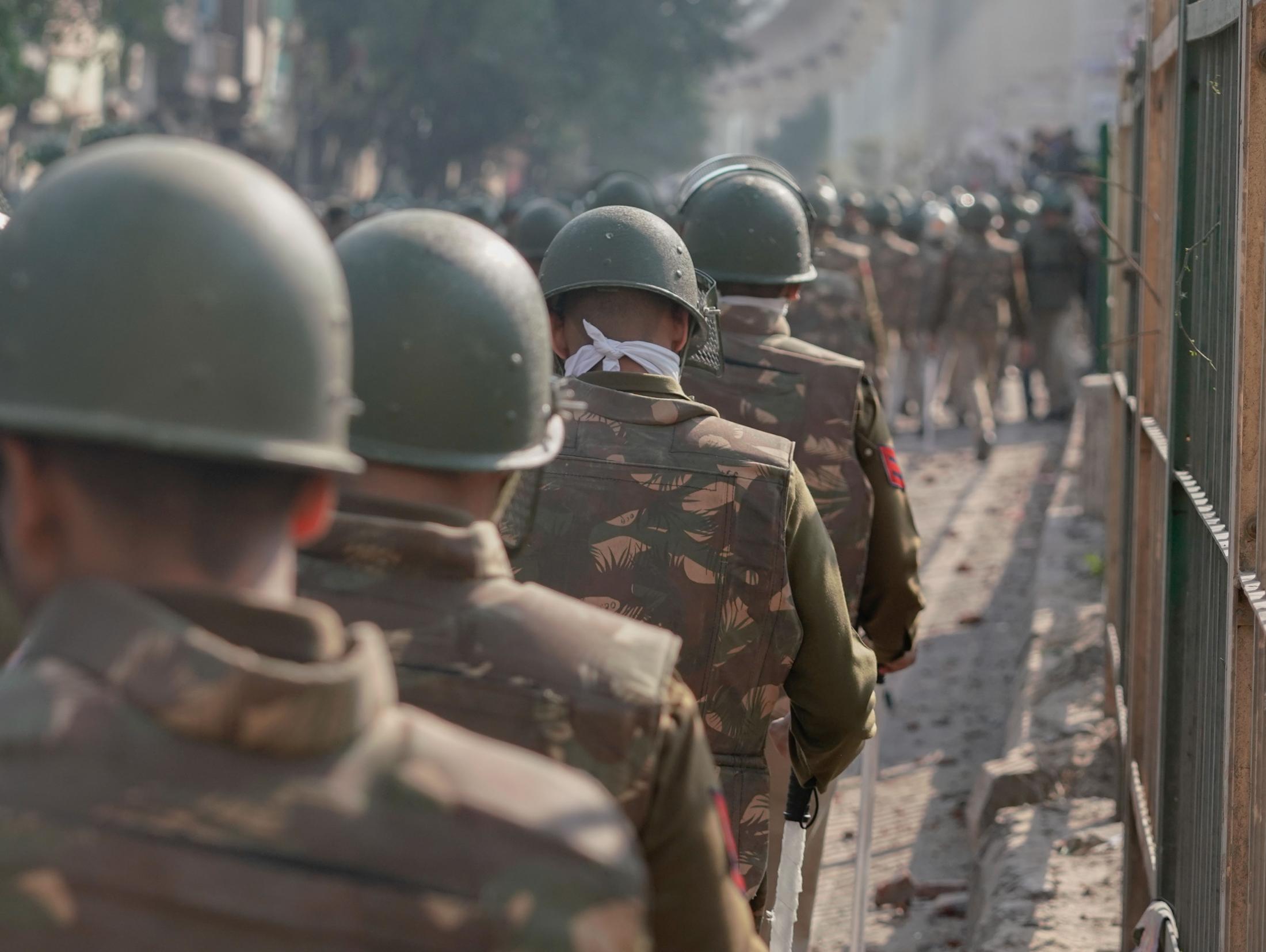 Aazadi - Delhi riot police walk in a line towards the frontline of...