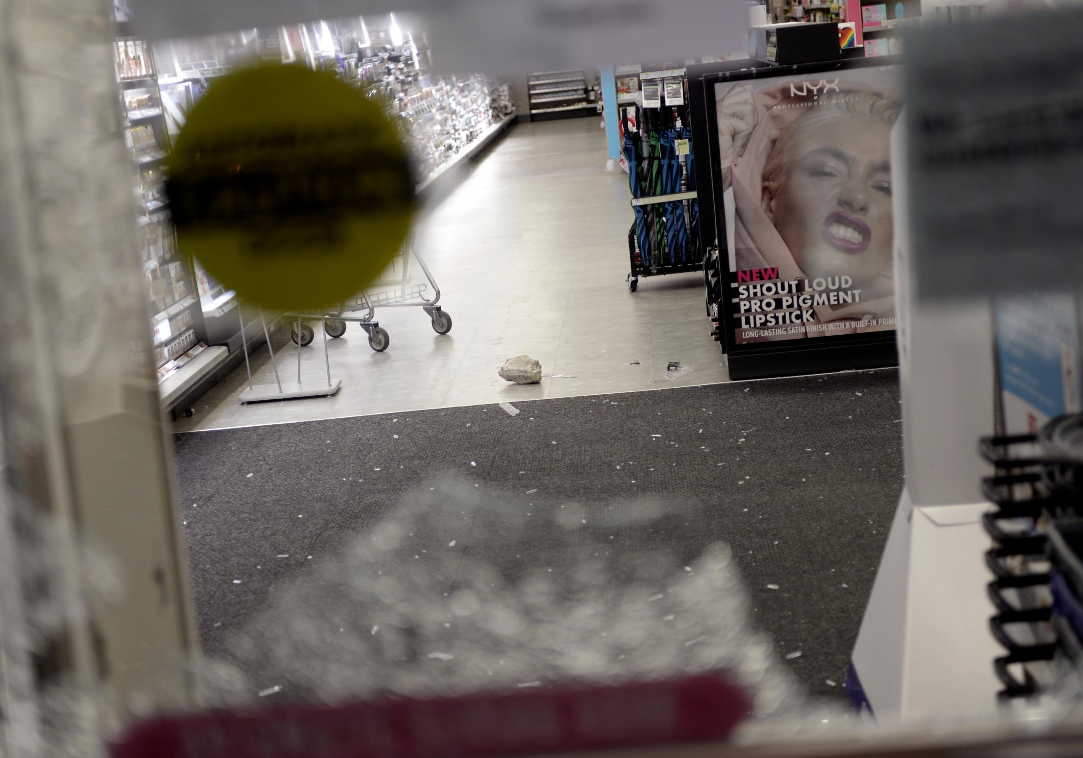 A Summer of Social Justice - A rock lays on the floor of the Walgreens at the...