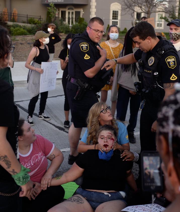 A Summer of Social Justice - Anna Knipfel is helped by protesters and police officers...