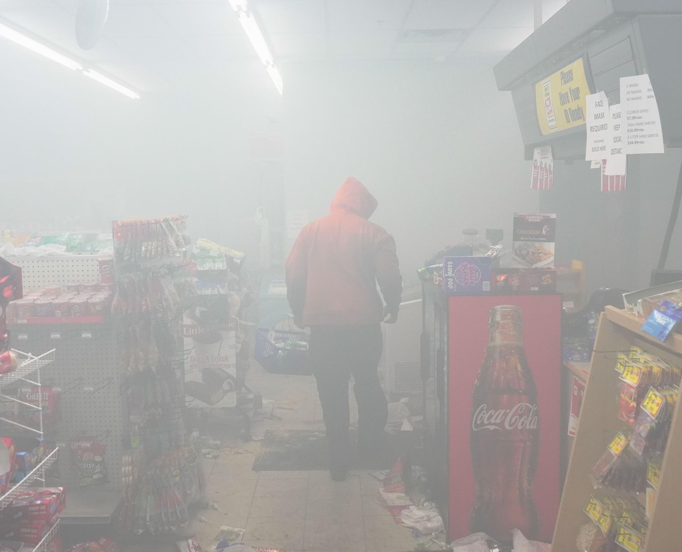 The BLM Summer - A looter walks through a convenience store on Friday, May...