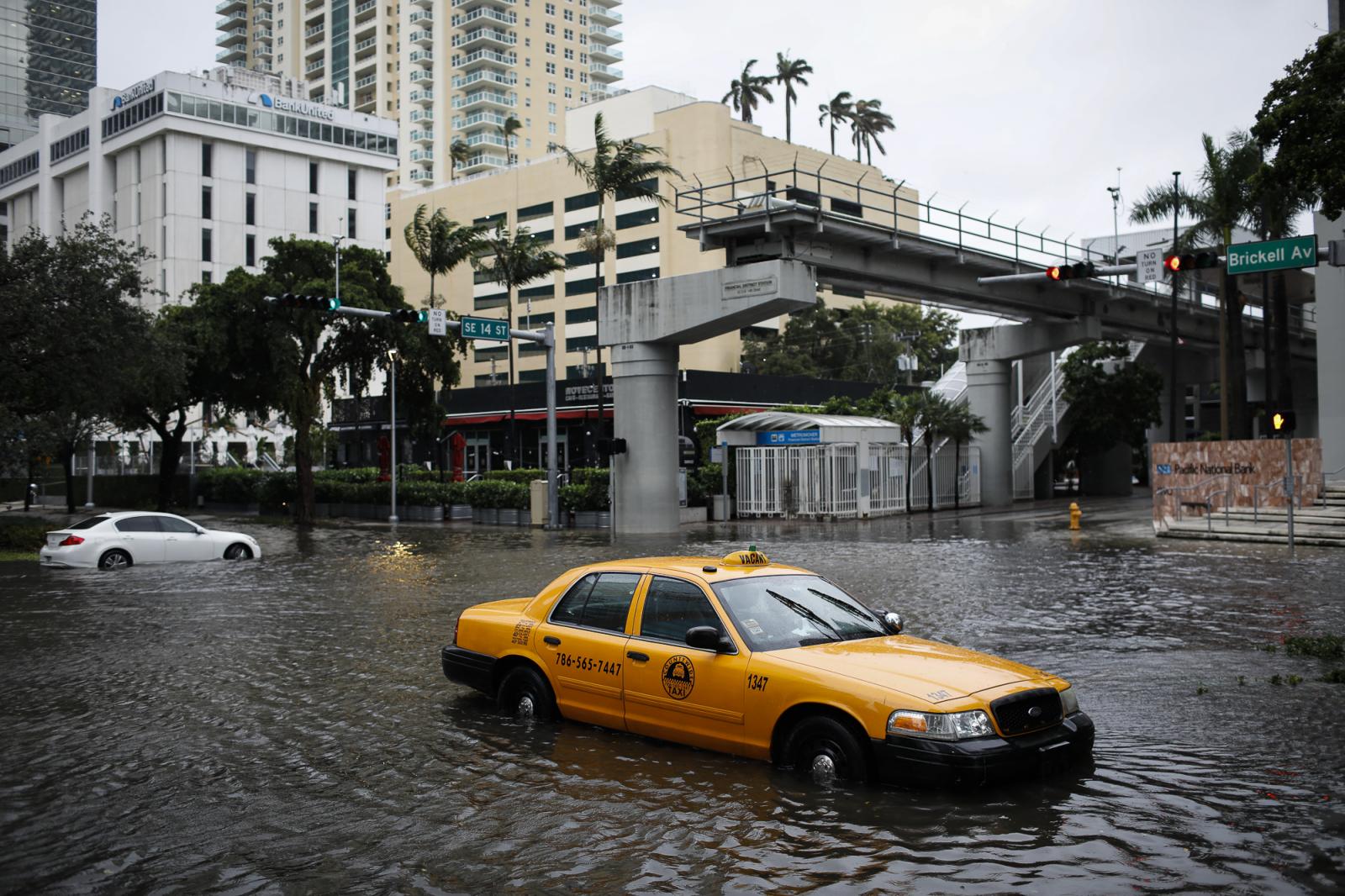 A damaged taxi is seen in flood...er 9, 2020. REUTERS/Marco Bello