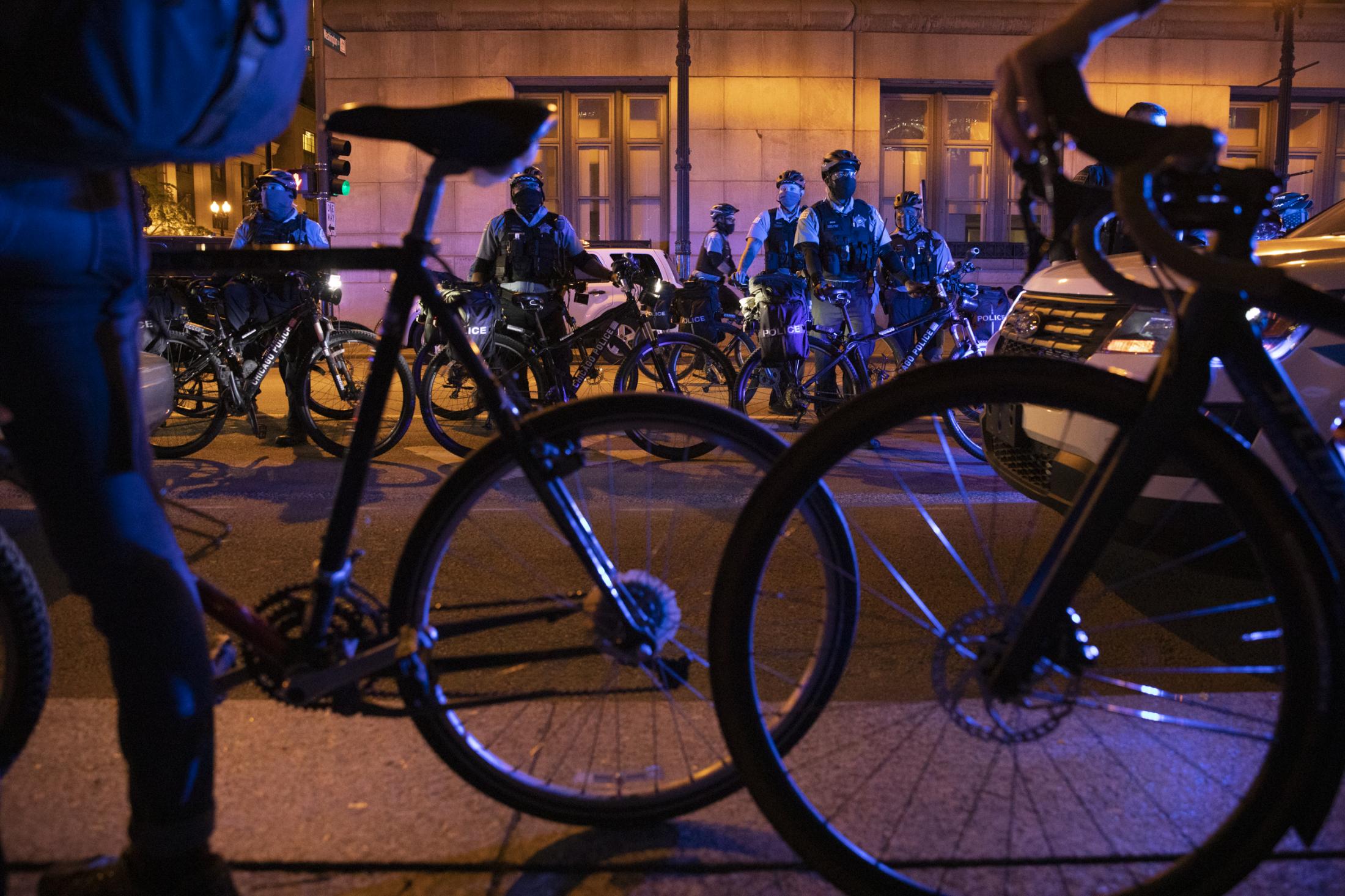The New Reality - Protesters form a barrier with their bicycle as Chicago...