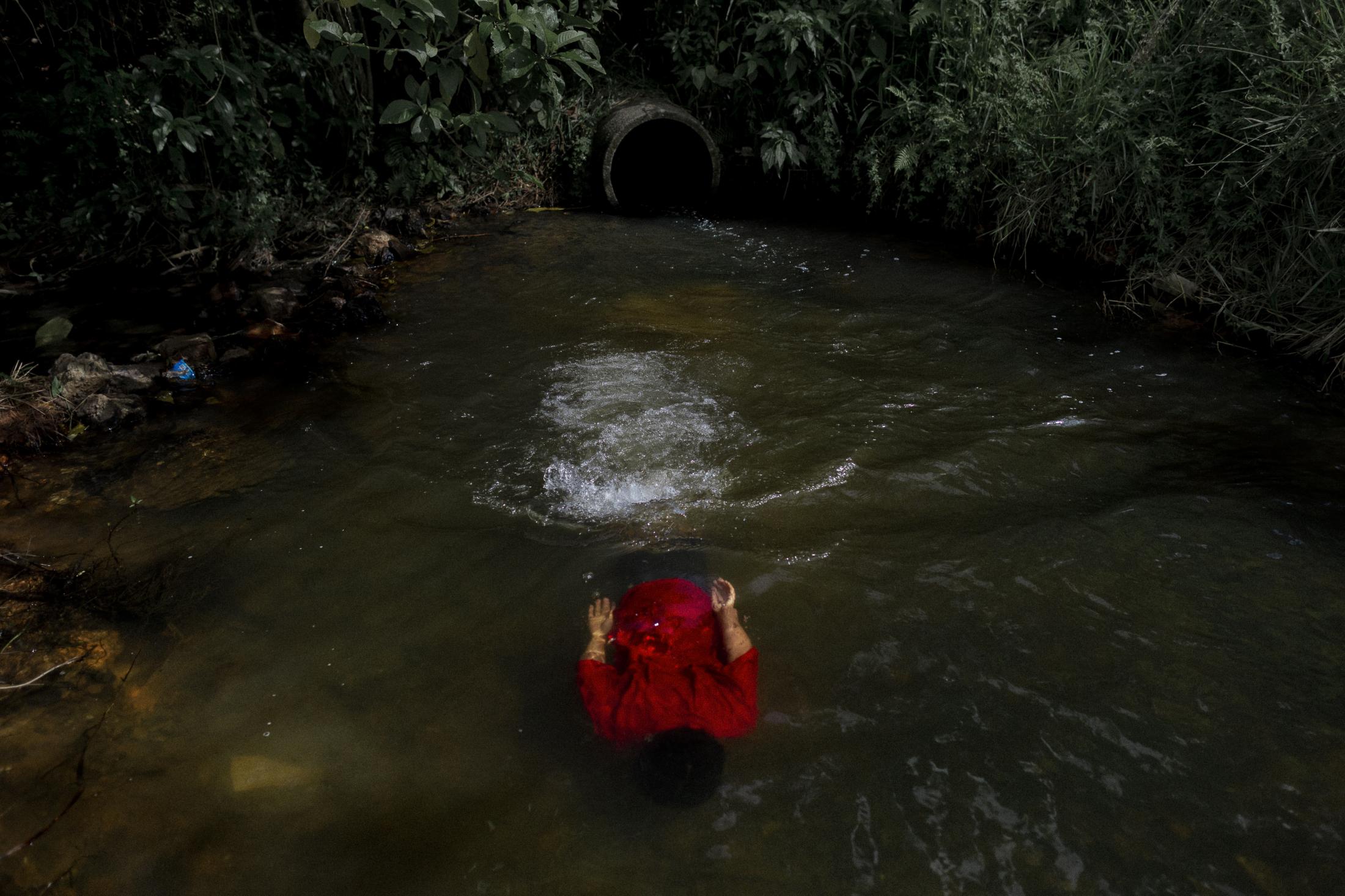 Forest Ruins (ongoing)  - A Guarani child swims near his village. The pressures of...