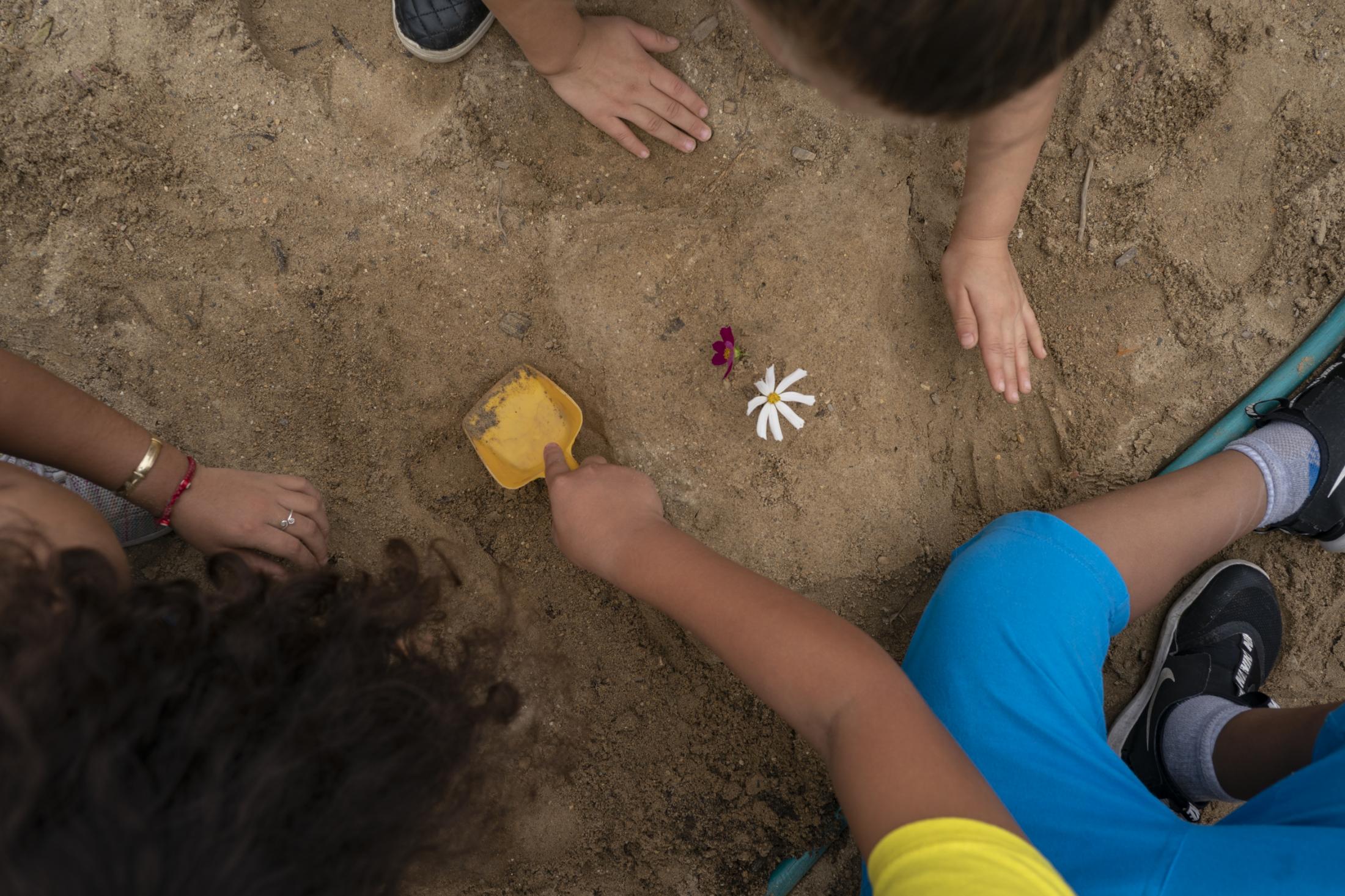 Little Village - Young attendees play in the dirt during the annual...
