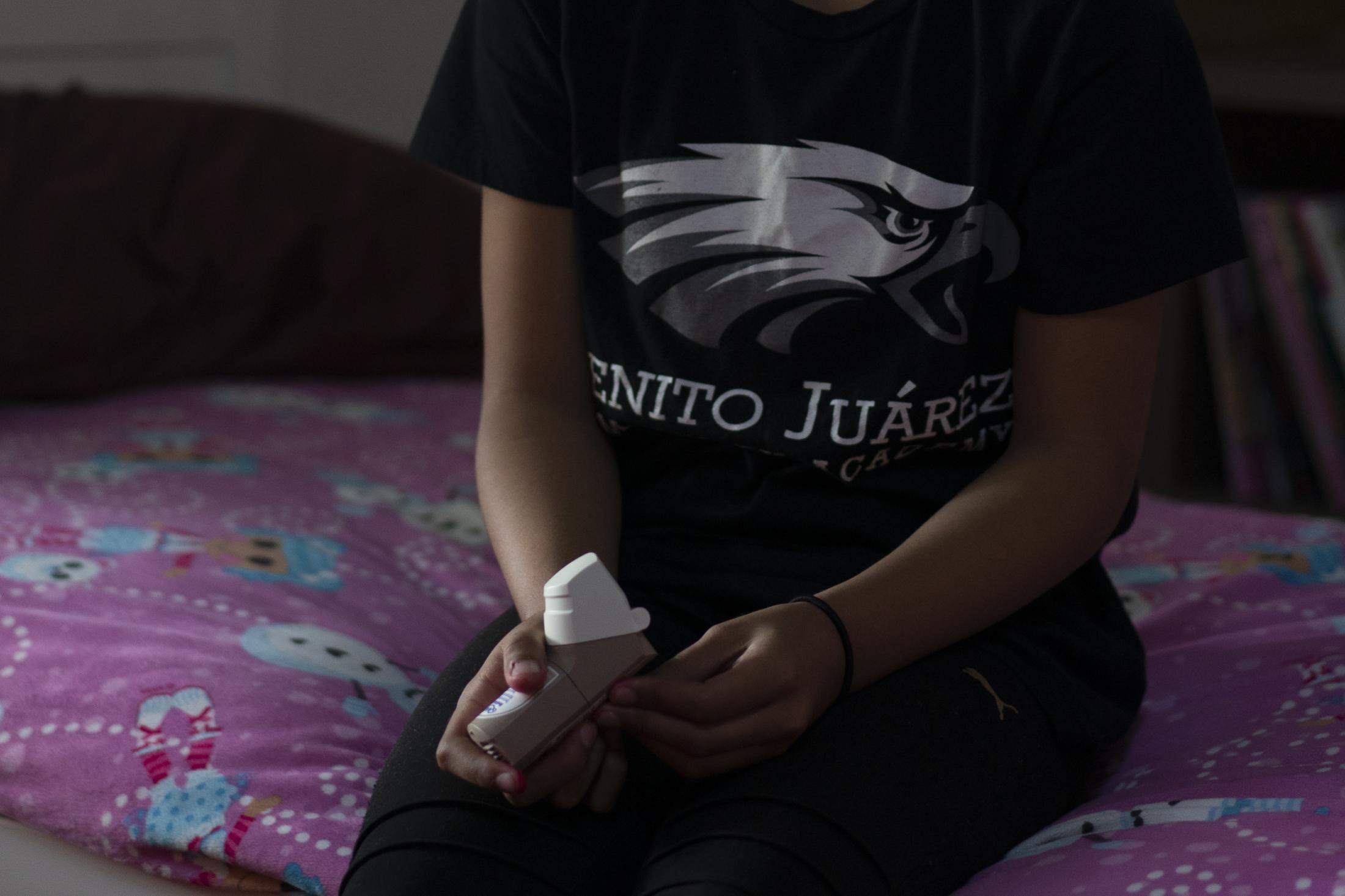Little Village - Gabriela Wasserman, 11, uses her inhaler in bed at her...