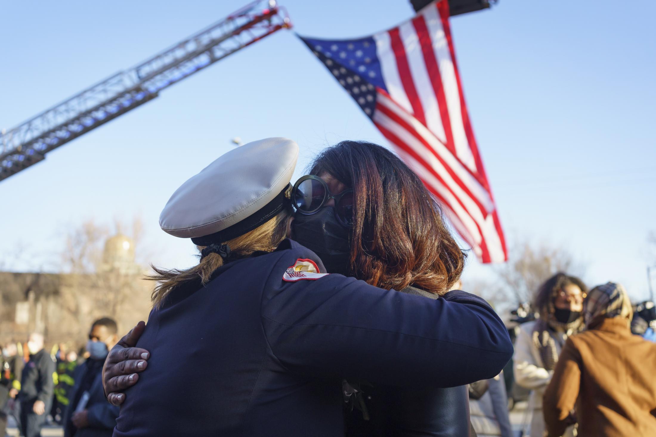 The New Reality - A Chicago firefighter hugs Demeka Ankum, whose husband...
