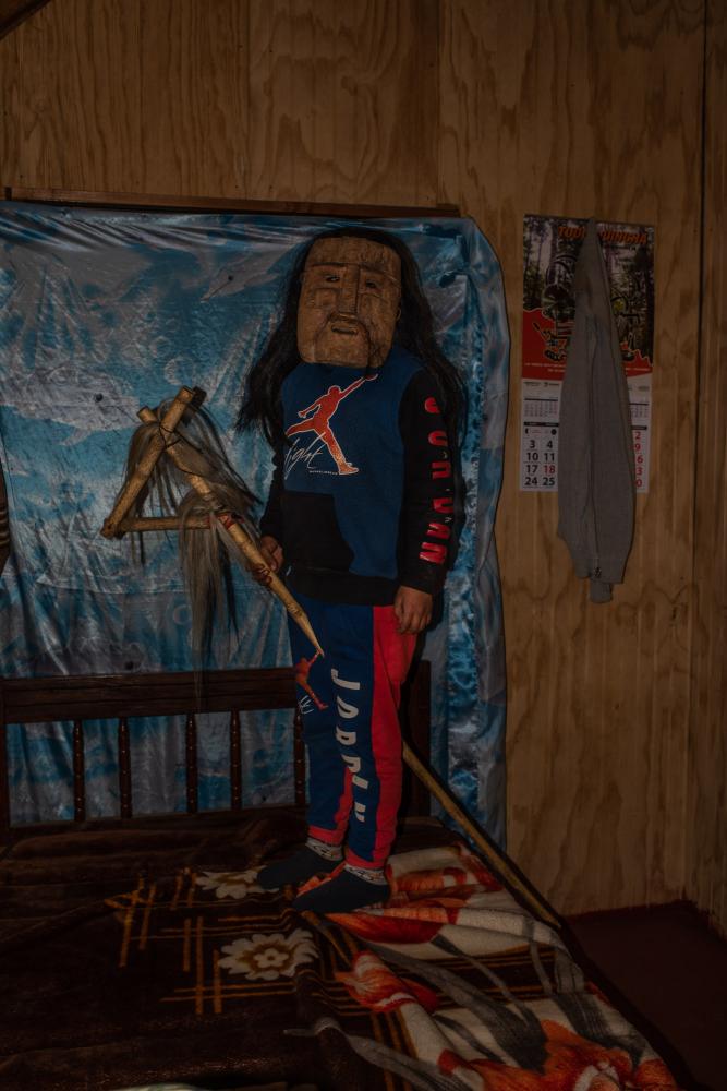 Weliwen Curamil(9) son of Alberto Curamil, Mapuche political prisoner and 2019 Goldman environmental prize, which he received in jail. In this photo Weliwen wears a Koll&oacute;n mask, used in Mapuche ceremonies to ward off evil spirits. CuracautiÌn, AraucaniÌa region, Chile. August 11th, 2019.