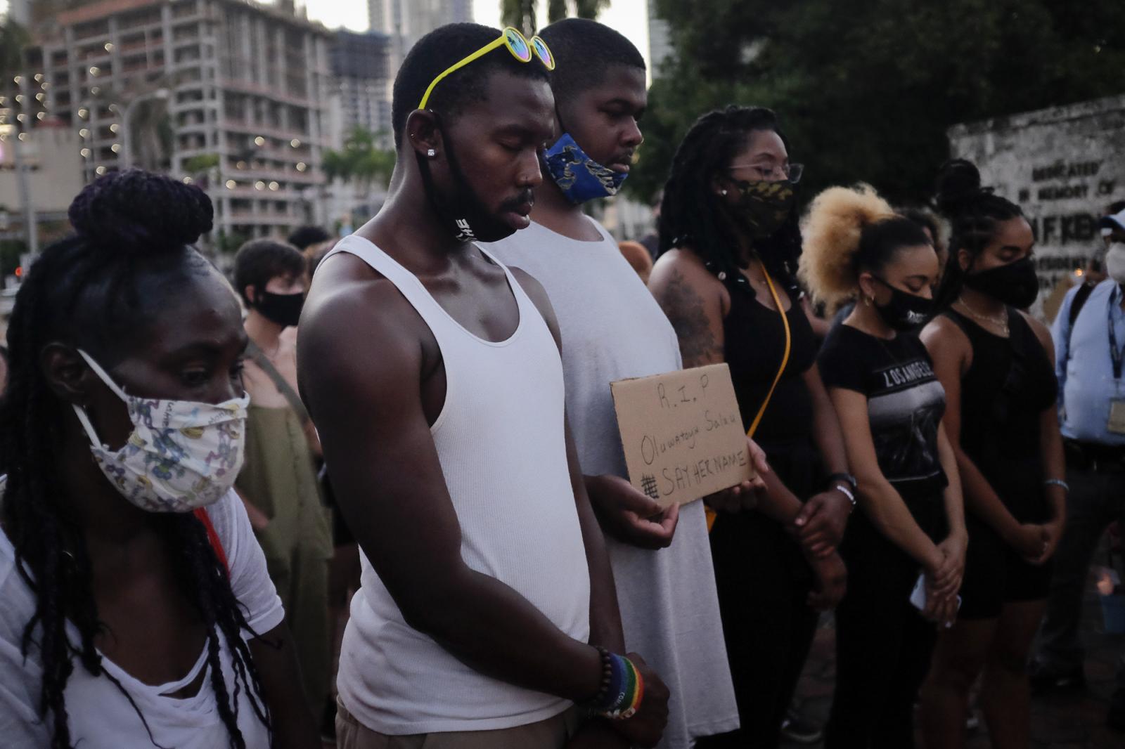 People attend a vigil for slain...e 16, 2020. REUTERS/Marco Bello