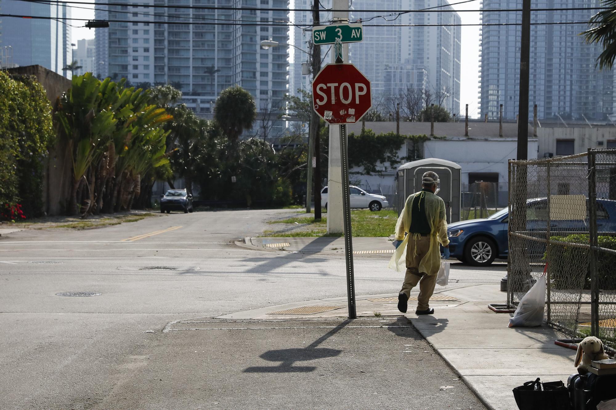 Miami-Dade County testing operation for the coronavirus disease - A worker walks in a street looking for homeless people...