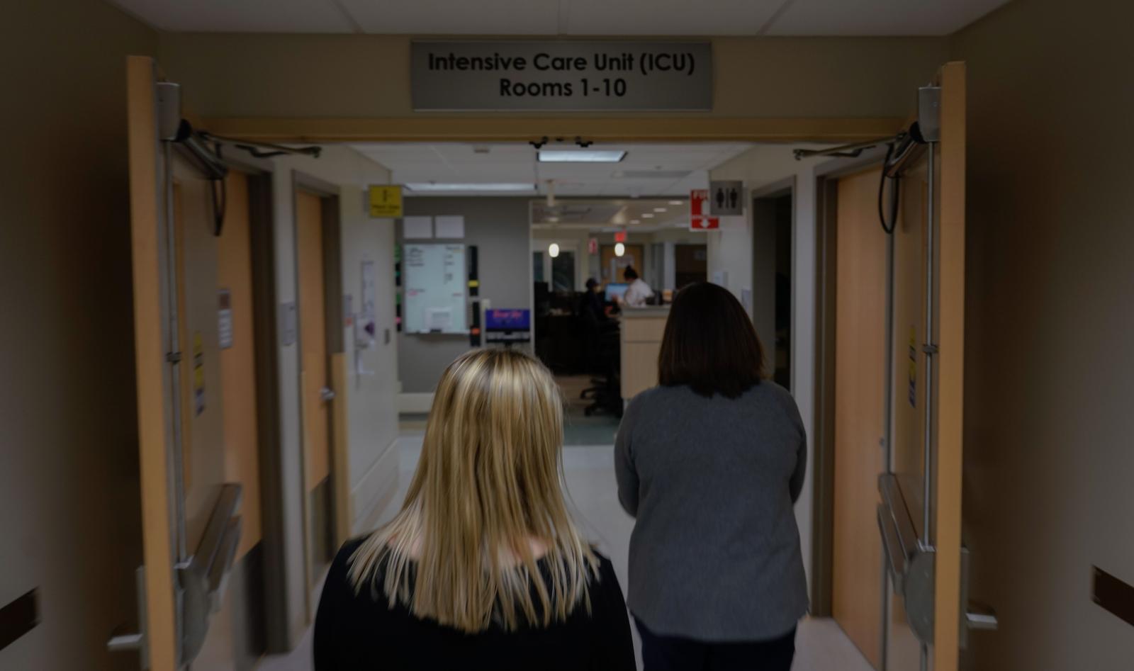 Two health officials enter the ...spital in Lake Saint Louis, Mo.