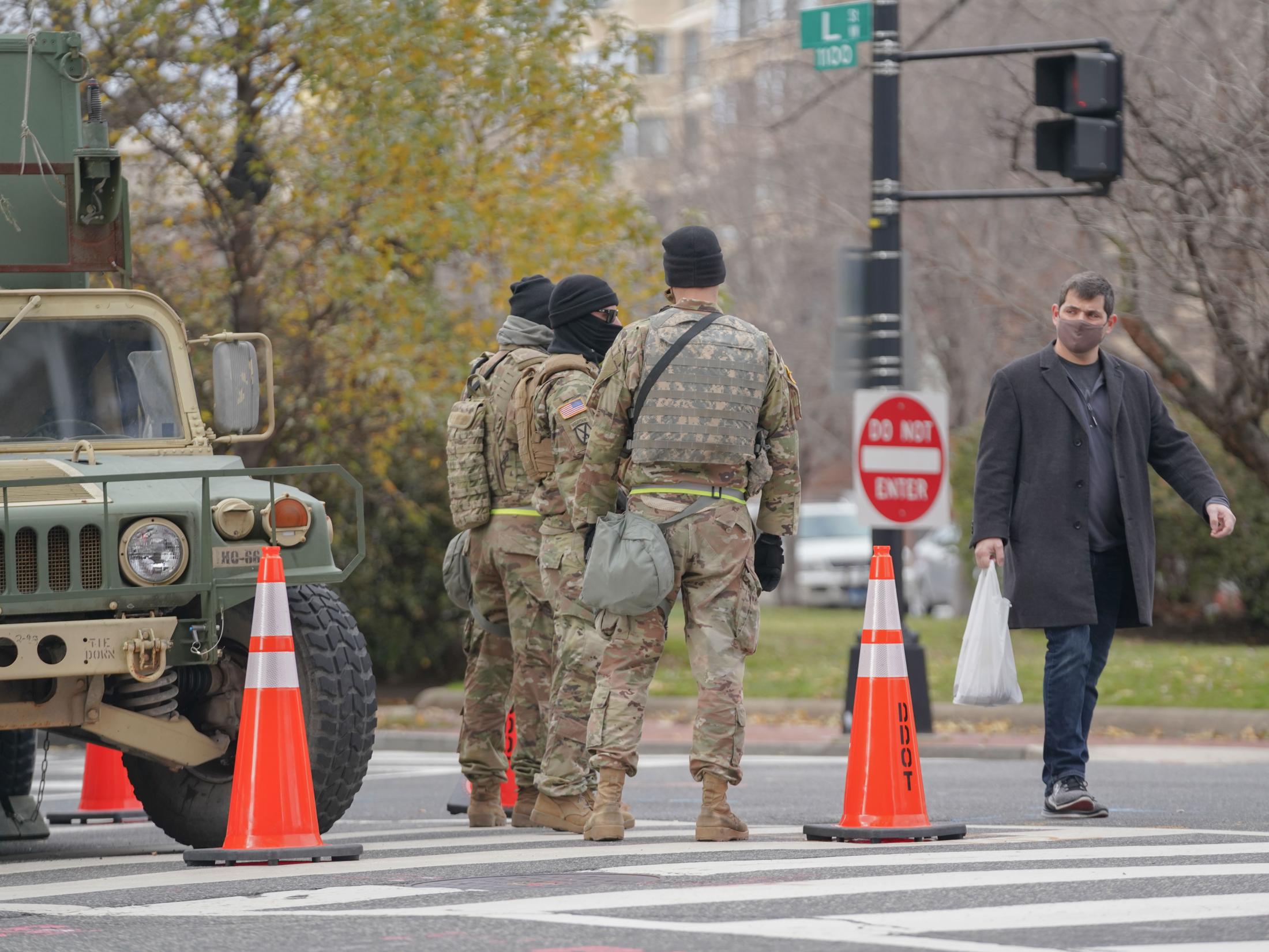 Occupied - A pedestrian walks by a military checkpoint on Sunday,...