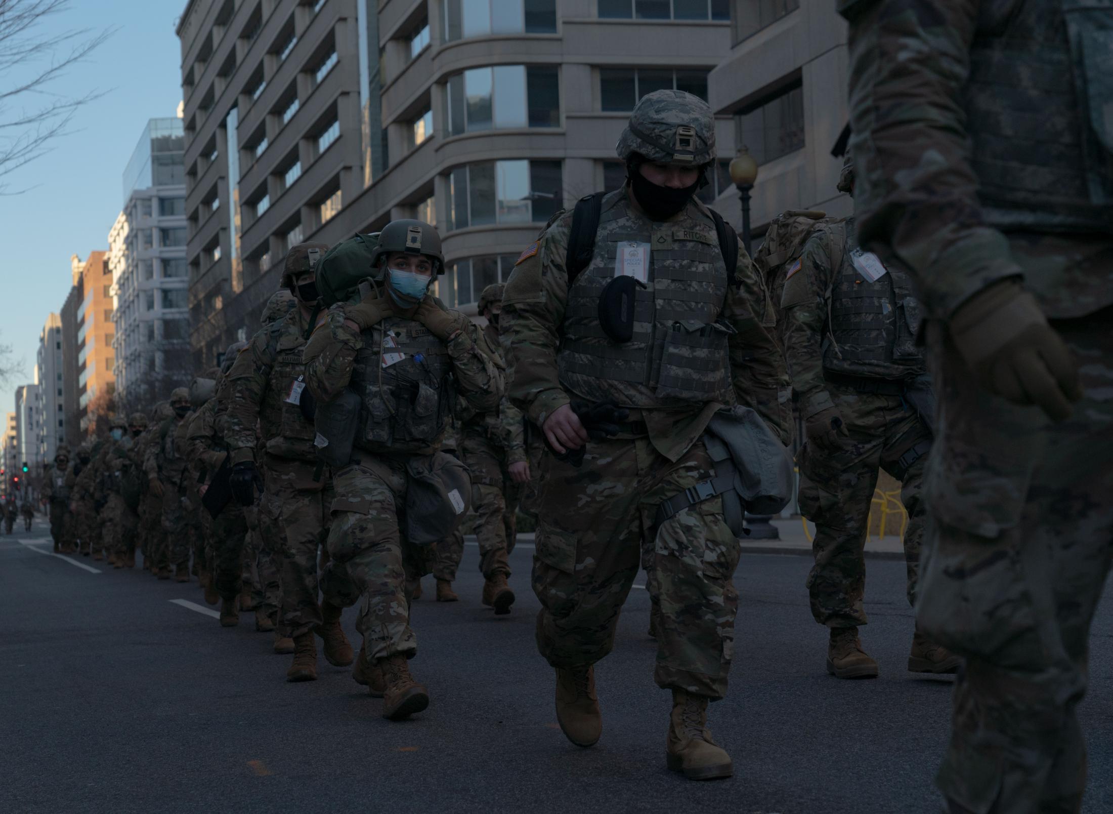 Occupied - National Guardsmen walk towards the National Mall during...