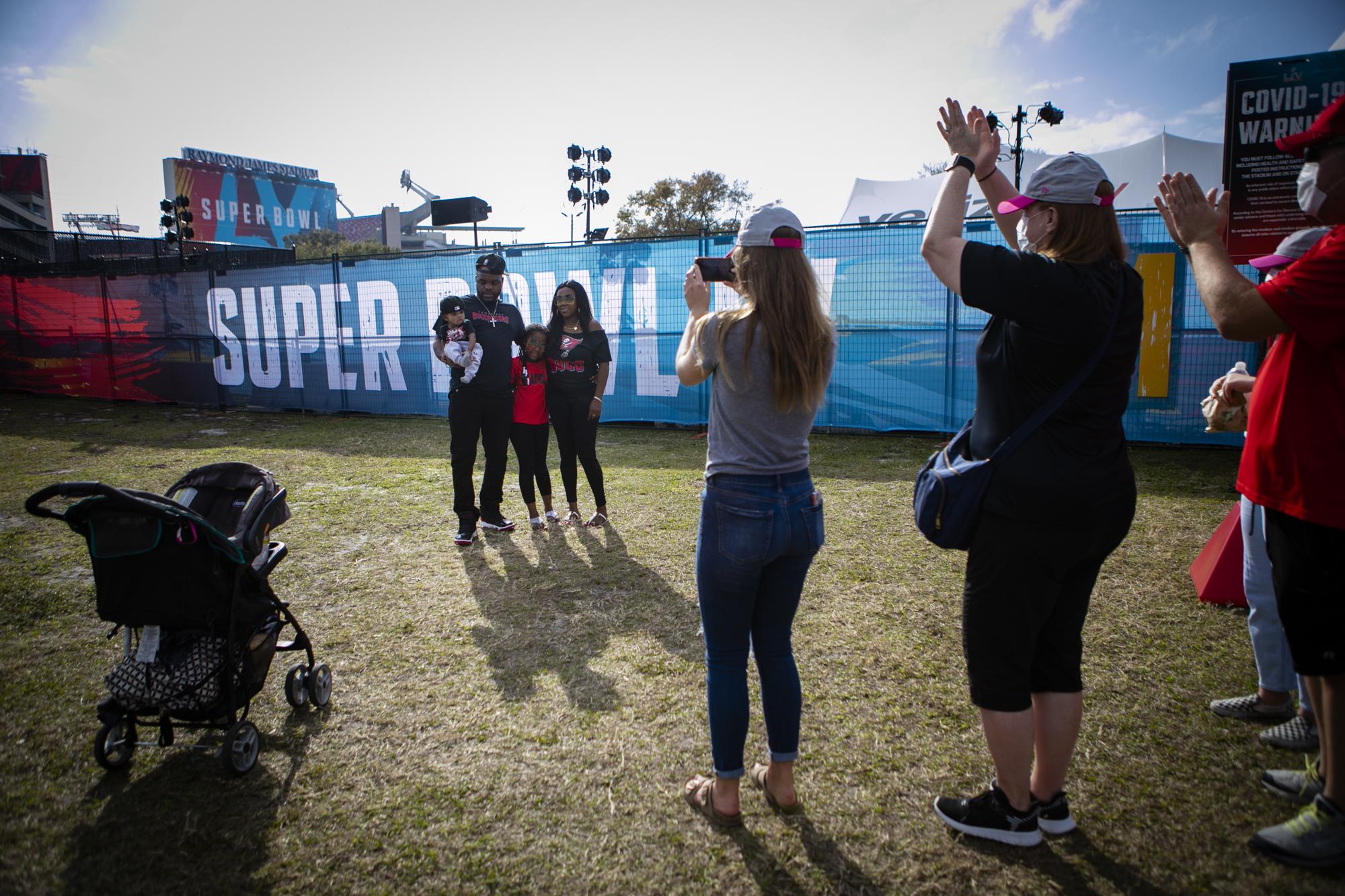 FLORIDA, USA - FEBRUARY 06: Fans pose for a photo outside Raymond James Stadium a day before the Super Bowl LV, in Tampa, Florida, United States on February 06, 2021.