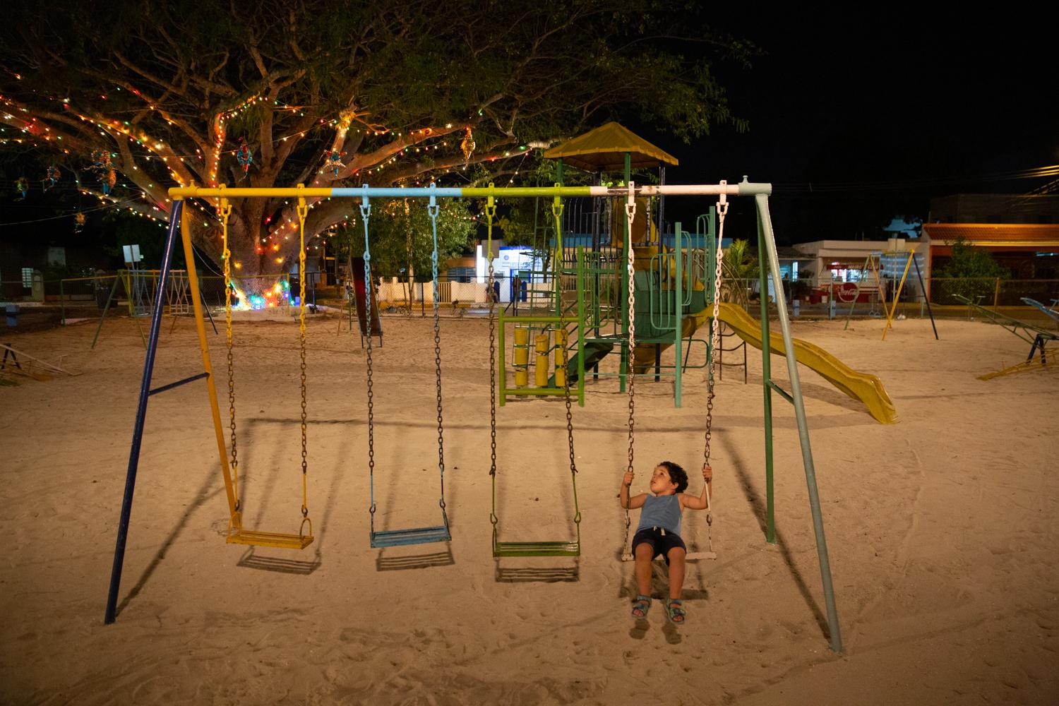 Thiago playing on a swing in an...uring the coronavirus pandemic.