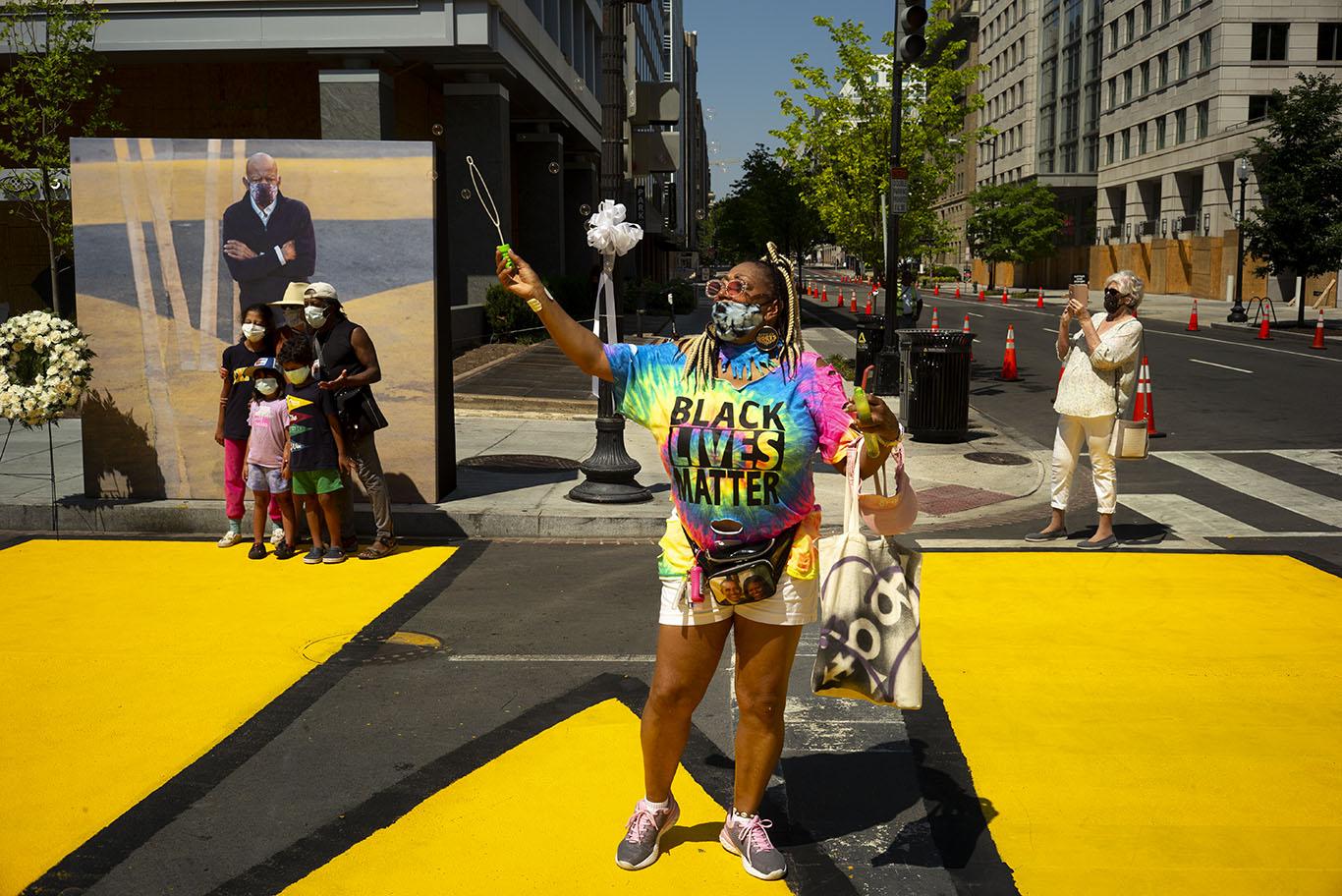 Washington D.C. - July 27, 2020. Events at Black Lives Matter Plaza in Washington D.C. before and during the hearse of the late John Lewis rolls by...