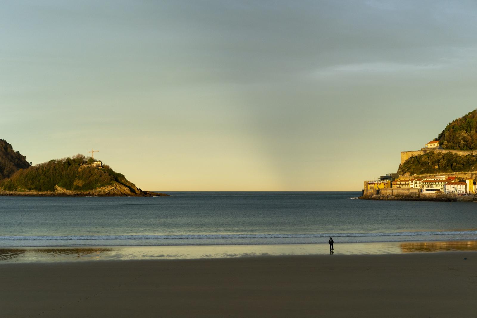   -  Ben walks on the sand at the Concha beach at sunrise in San Sebastian, Spain, on December 16,...