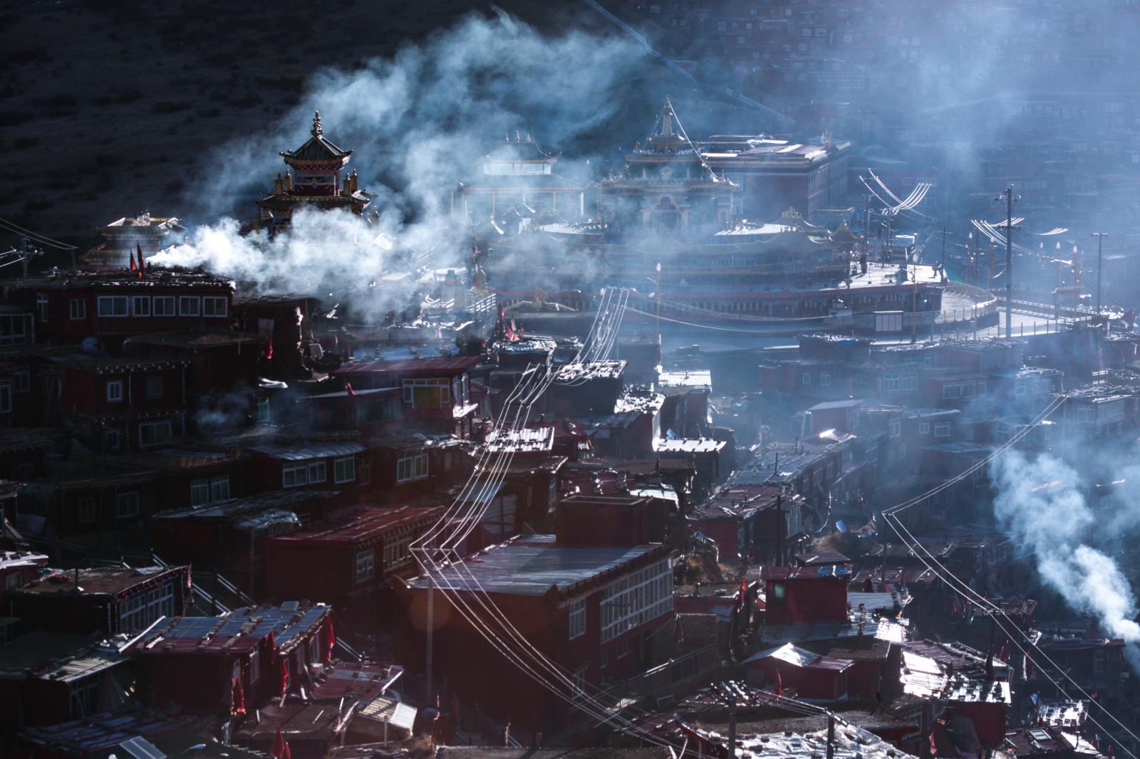In early morning, smoke rises f...th tens of thousands of monks. 