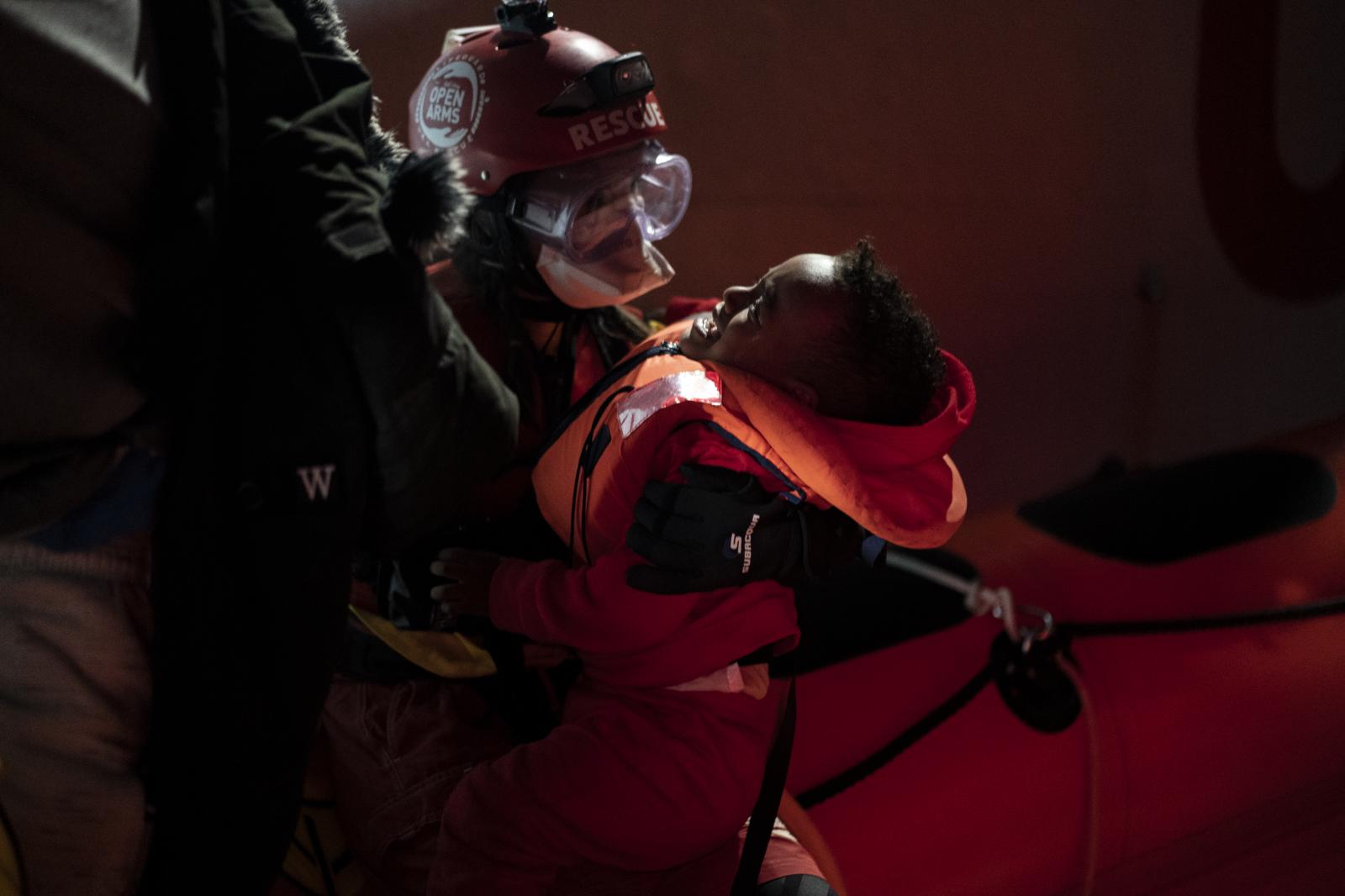 A baby is rescued by aid worker...31, 2020. (AP Photo/Joan Mateu)