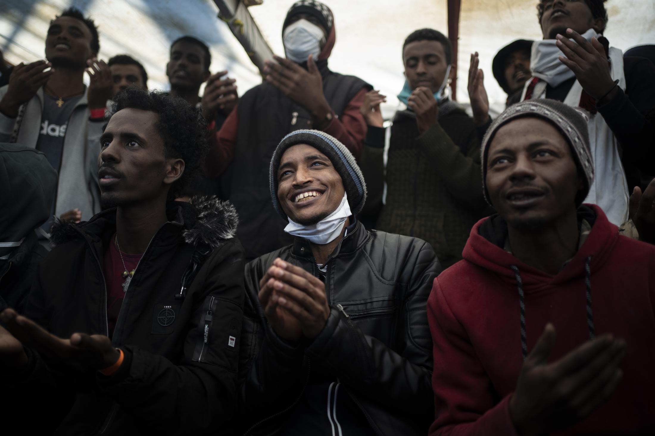 Open Arms #79 - Yohaness, from Eritrea prays singing as he arrives at the...