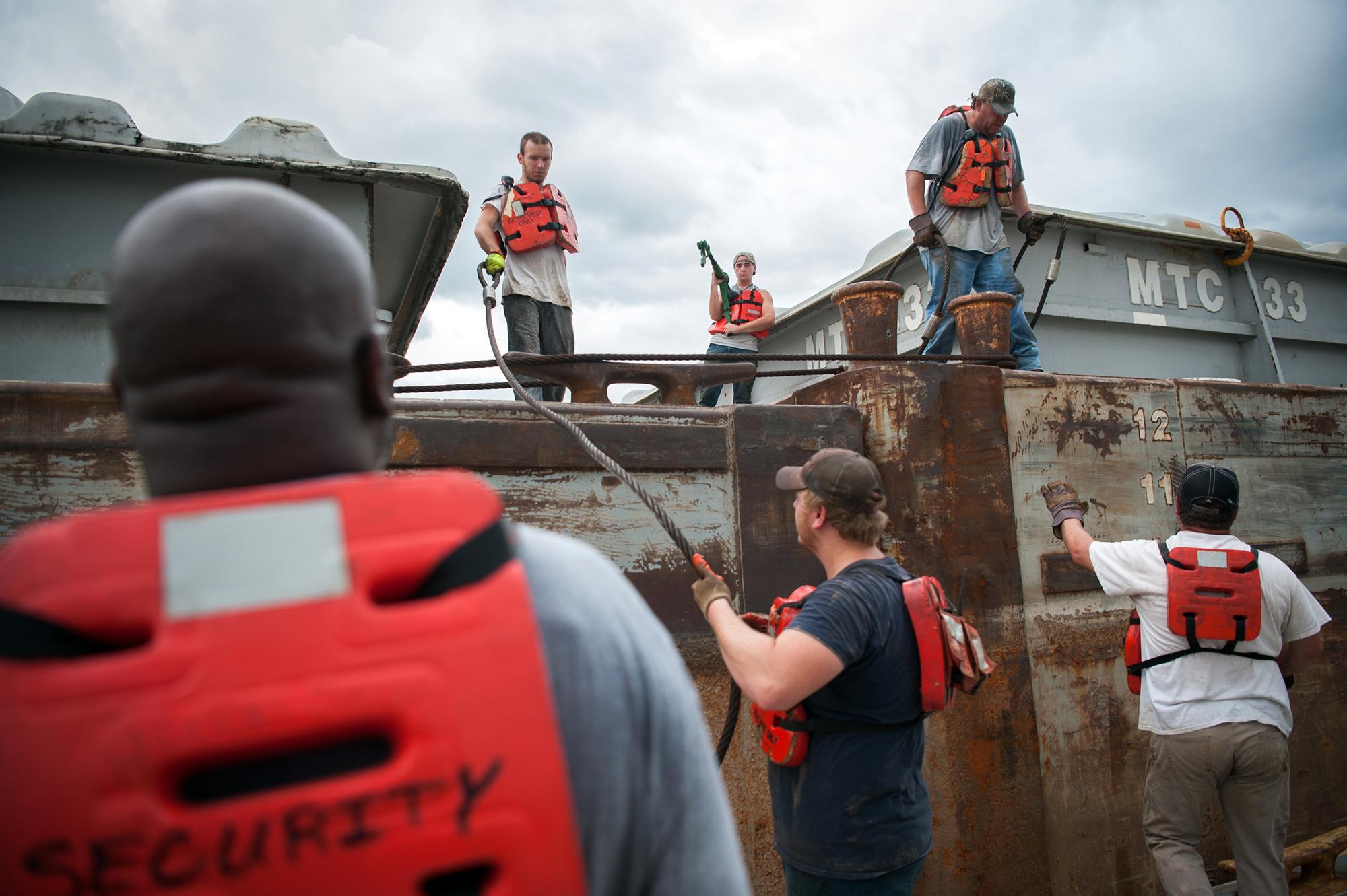 Modifying Mississippi - Crew Members organize a barge at the Port of Rosedale in...