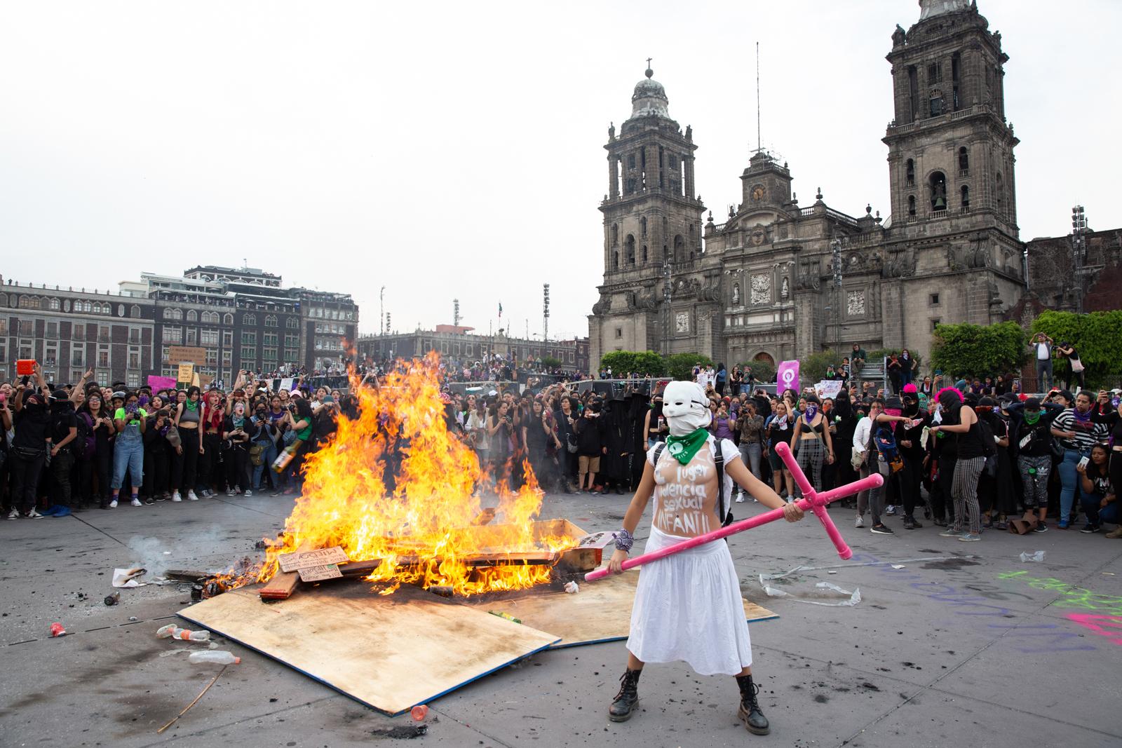 News - MEXICO  Demonstrators circle round a wood pile they set...