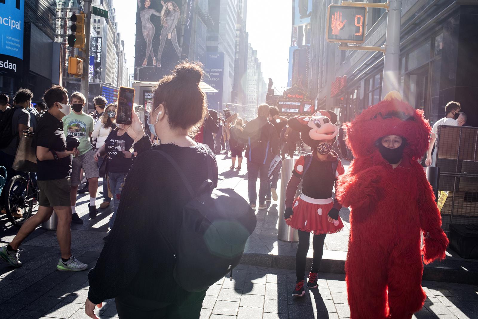 People gather in Times Square ...ction of Joe Biden and others.