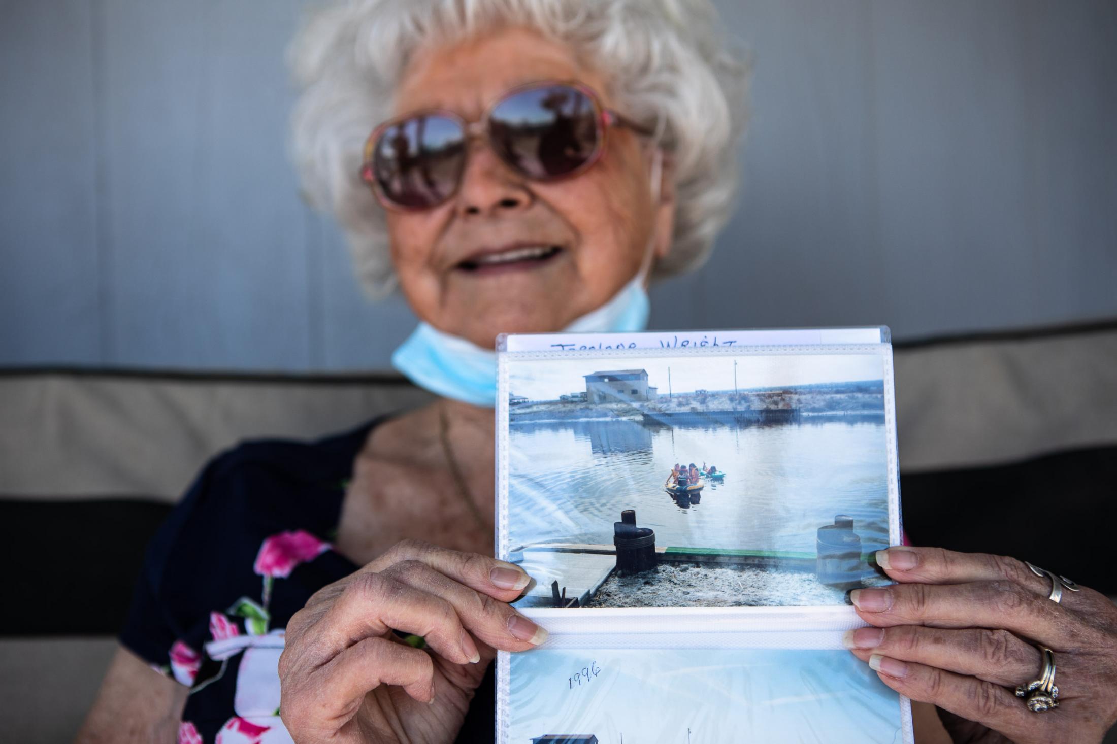  - The Salton Sea faces a crisis  -  A resident of Desert Shores holds a picture taken in...
