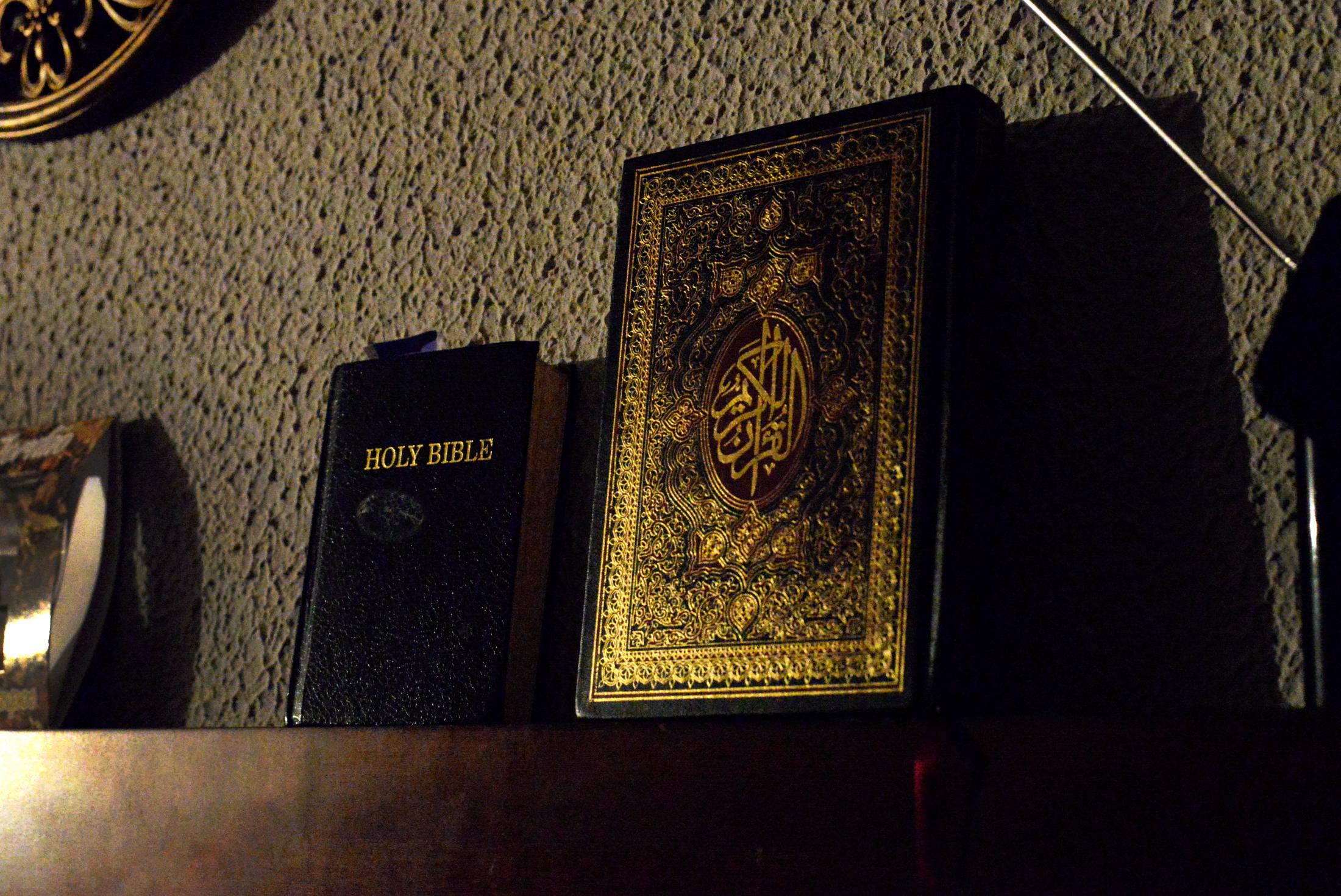 In Between Cultures - A Bible lies next to a Quran at Rama AlOmari’s home...