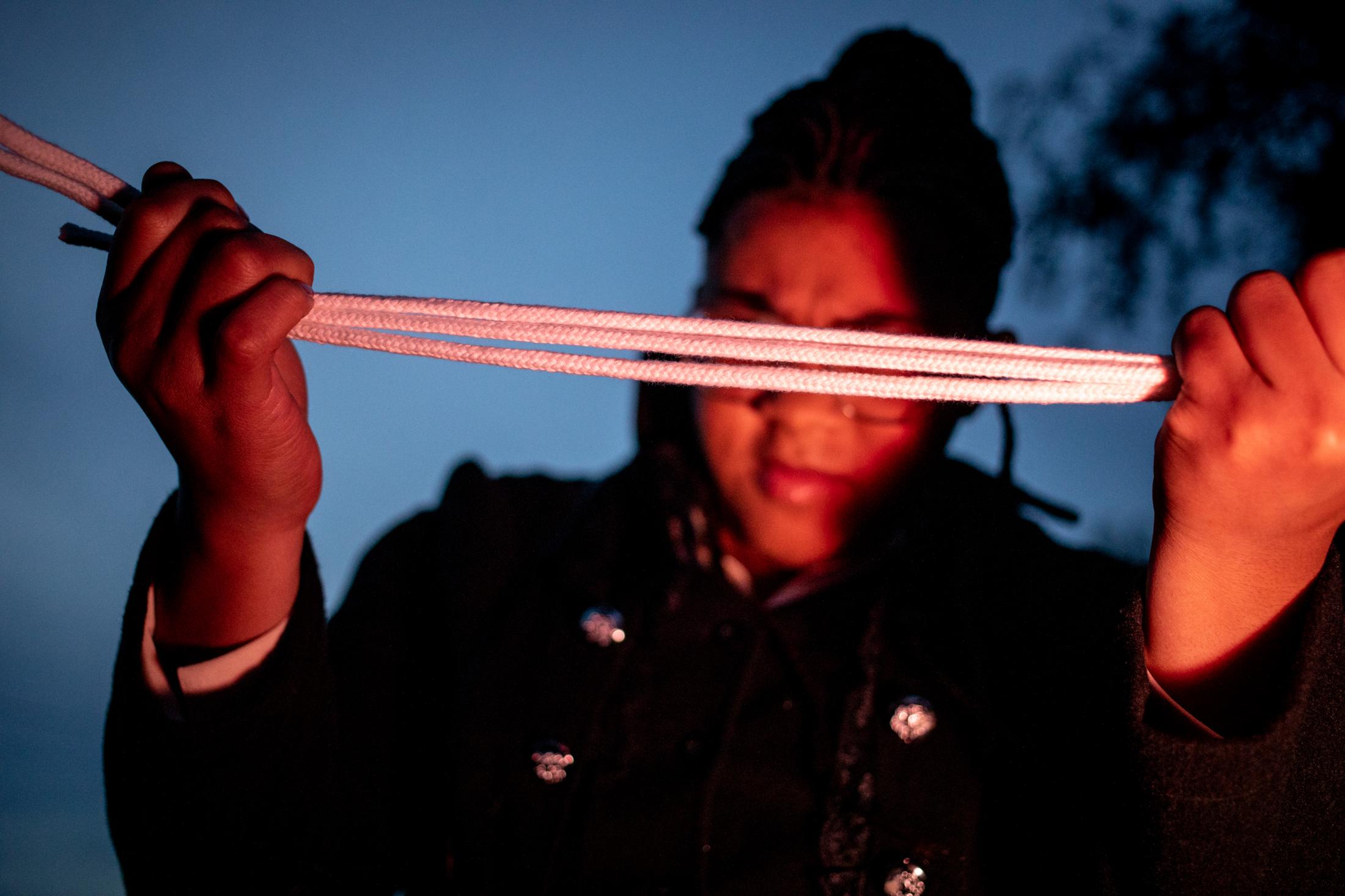 Break a Thread -  Leroya Sanford, 17, performs a trick with magic ropes at...