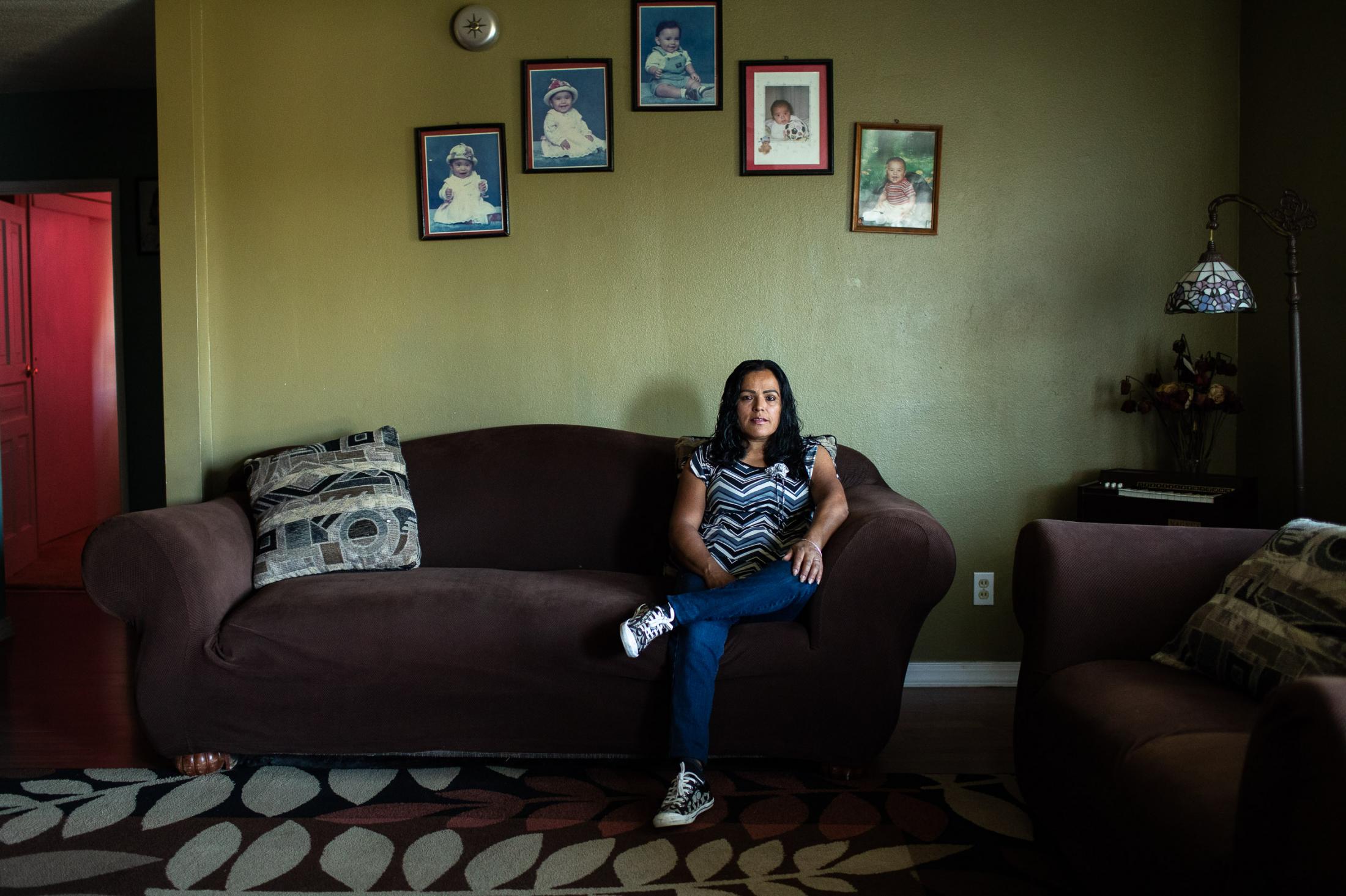  Fidelia Morales sit&#39;s in the family living room below the pictures of her 5 childern. The mother of five moved to the area about 12 years...