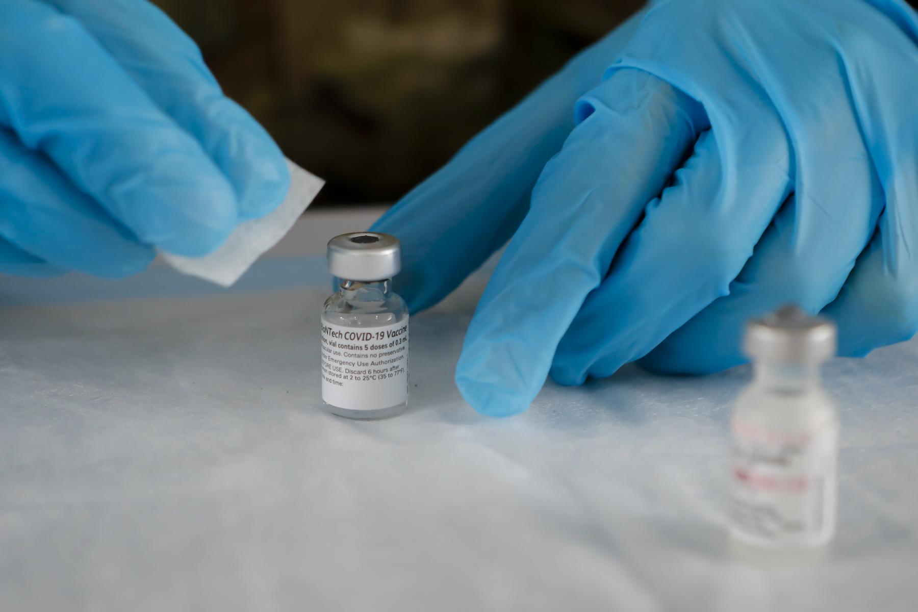 FEMA vaccination facility in North Miami - A Pfizer - BioNTech COVID-19 vaccine vial sits on a table...