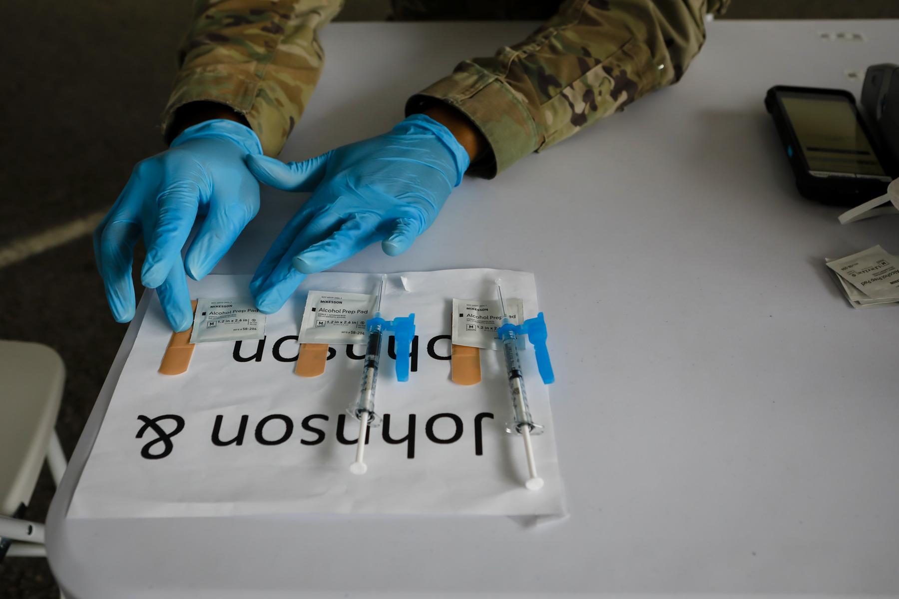 2021  - FEMA vaccination facility in North Miami - A U.S. Army soldier prepares to inoculate people with the...