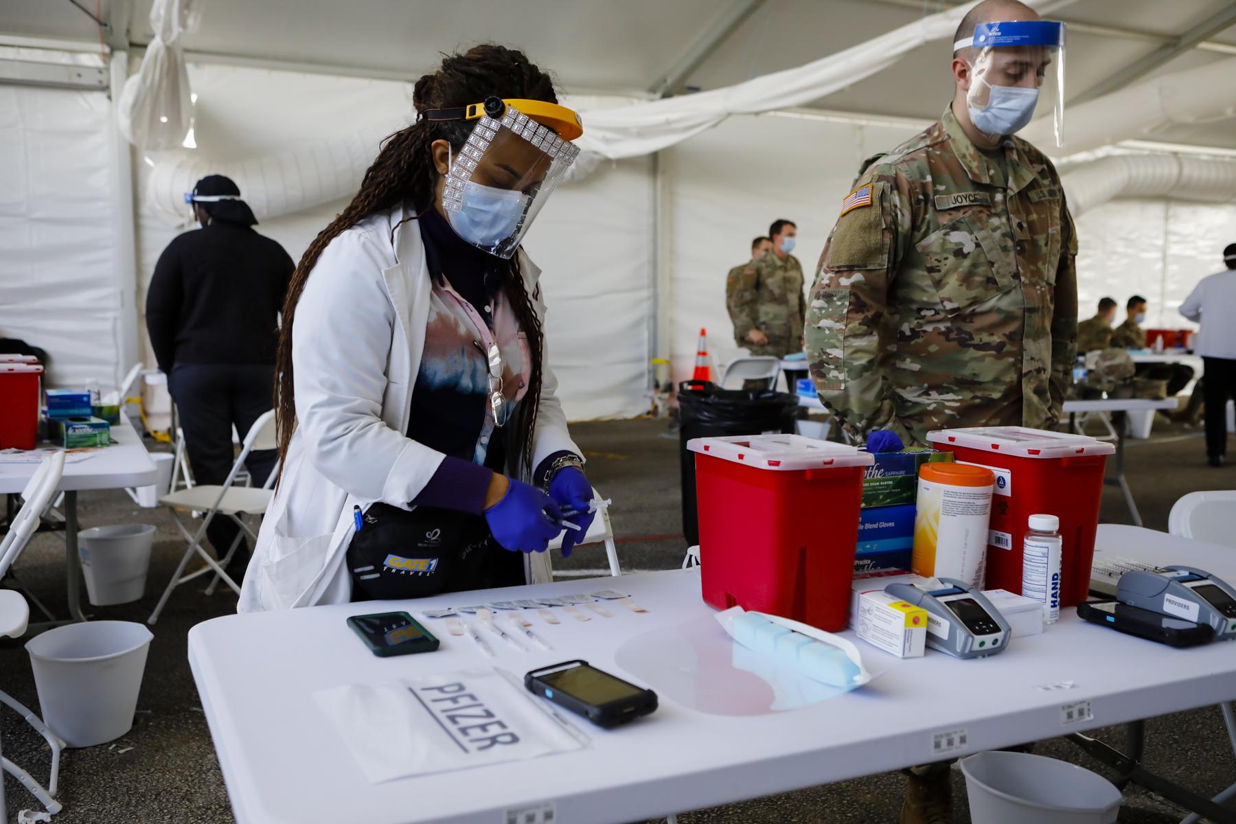 2021  - FEMA vaccination facility in North Miami - A health care worker prepares to inoculate people with...