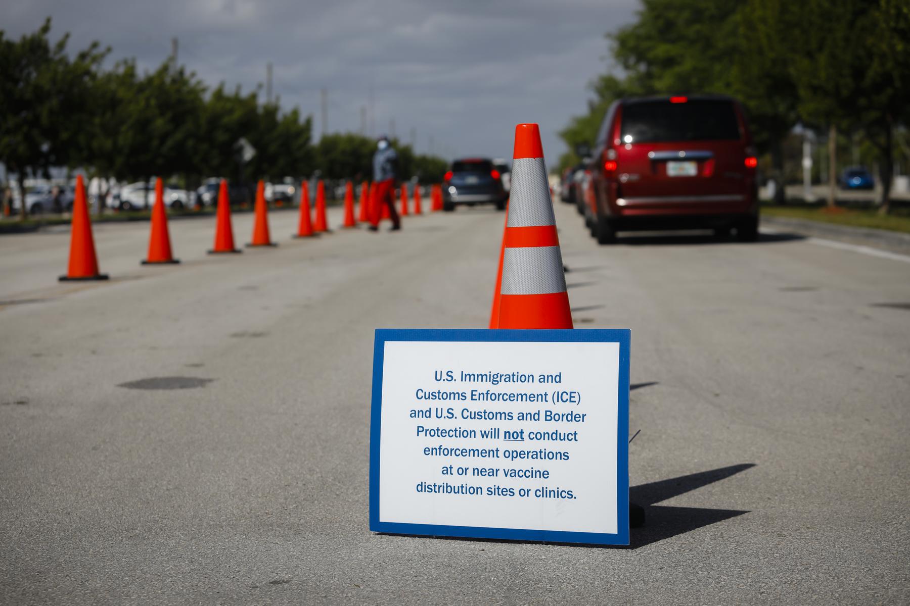 A sign with U.S. Immigrations Customs Enforcement (ICE) and Customs and Border Protection sits outside a COVID-19 Community Vaccination Center, a state-run federally supported by Federal Emergency Management Agency (FEMA) at the Miami Dade College North Campus in North Miami, Florida, US, on Wednesday, Mar. 10, 2021. Photographer: Eva Marie Uzcategui / Bloomberg