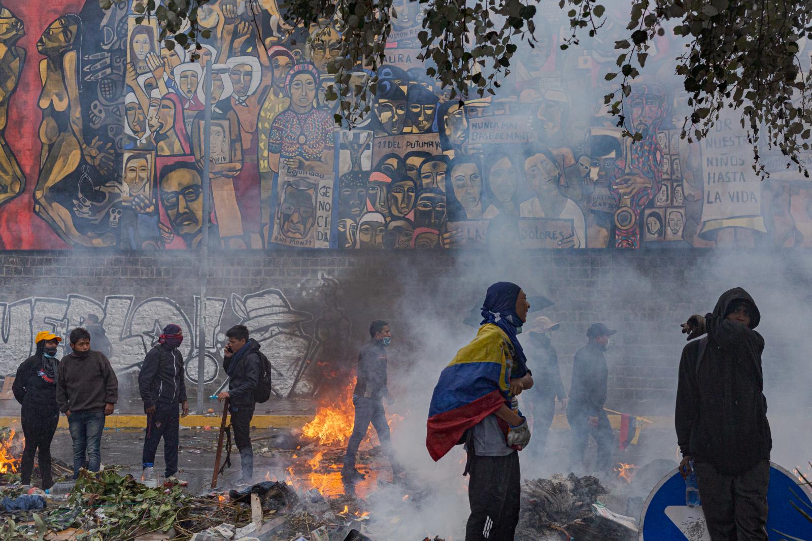 Demonstrators of the indigenous uprising in the afternoon of October 13, 2019, retreat in the middle of the rain before the launching of several tear gas bombs by the national police on the grounds of the Ecuadorean Culture House. Quito, Ecuador.  