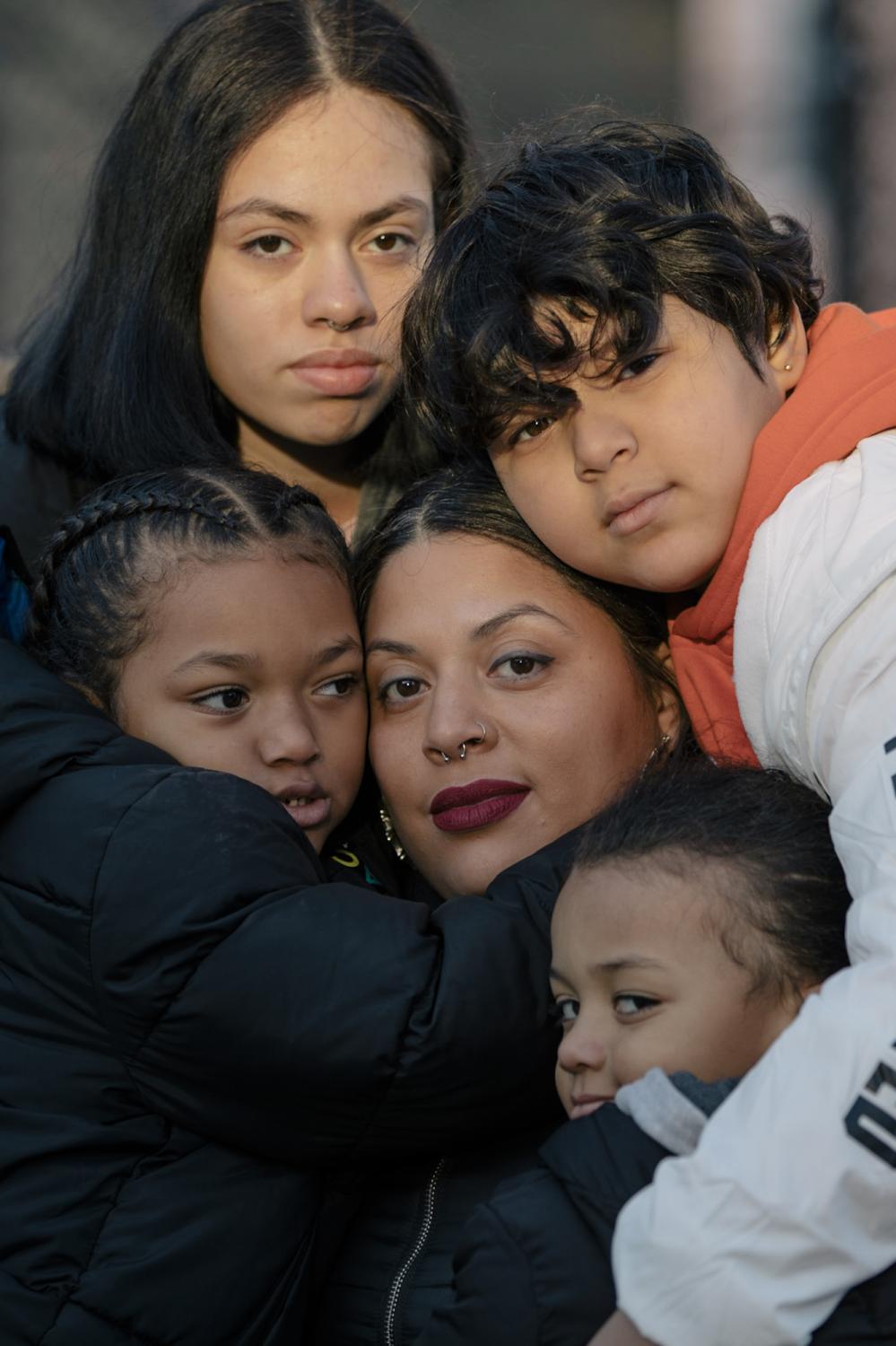 New York City, New York &mdash; December 10, 2020: Karen Roman with her children Zeniah Lopez, Joel Rodriguez, King Browing, and Kamren Browing outside of their old apartment on E118th Street in Spanish Harlem. After a car accident and the COVID-19 pandemic derailed Karen Roman&rsquo;s college plans, she has concentrated her energy on starting a makeup business to help provide for her young family. CREDIT: Jos&eacute; A. Alvarado Jr. for The New York Times