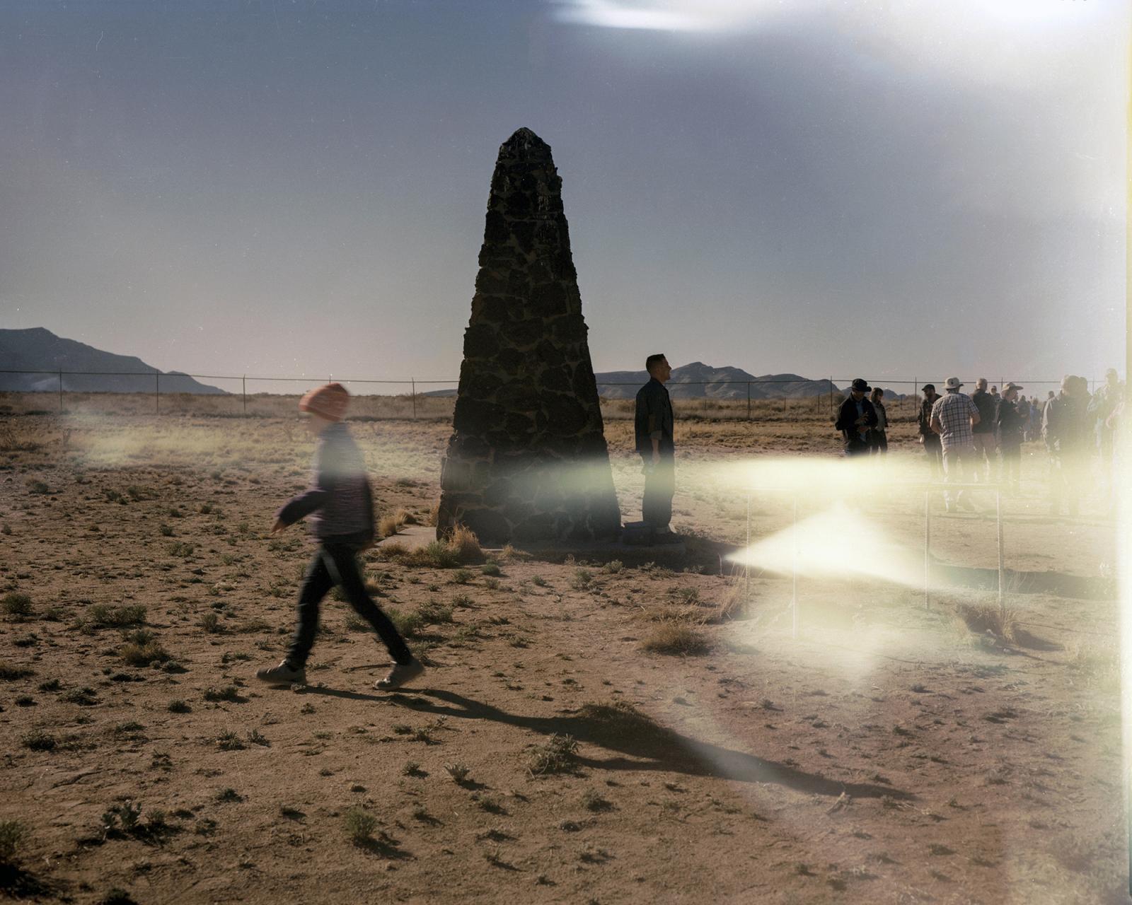 Trinity site, White Sands Missile Range, New Mexico, USA, April 2, 2016  The public gathers around the obelisk monument to the &nbsp;first atomic bomb detonation July 16, 1945. &nbsp; Radiation spread at least as far as Indiana, and the Wabash River, where Kodak Film Company sourced water for its paper mill to package its film. &nbsp;Customers ended up complaining that their film was fogged and the company secured a pledge form the Atomic Energy Commission to provide Kodak with dates and fallout patterns for future tests, thereby notifying corporate America, but not the American people, of the radiation risk. Today the site is a closed military zone opened only two days a year to public. &nbsp;Higher than normal radiation levels are still detected and residents of New Mexico claim that they have suffered cancer for generations as a result of the test but have never been compensated.