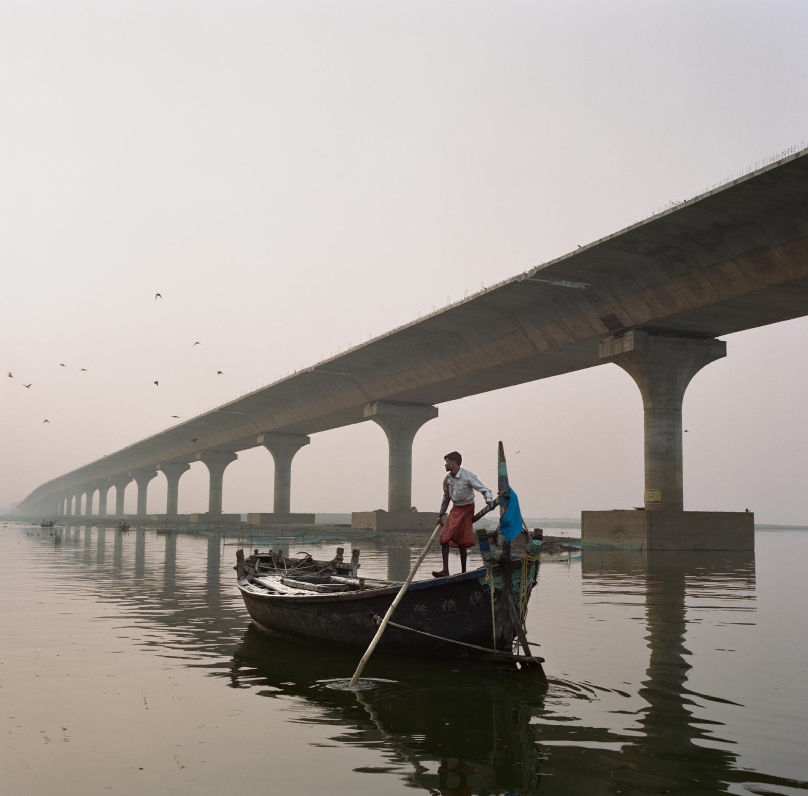Saving India's Holiest River? - In Patna, a boatman surveys the Ganges near a recently...