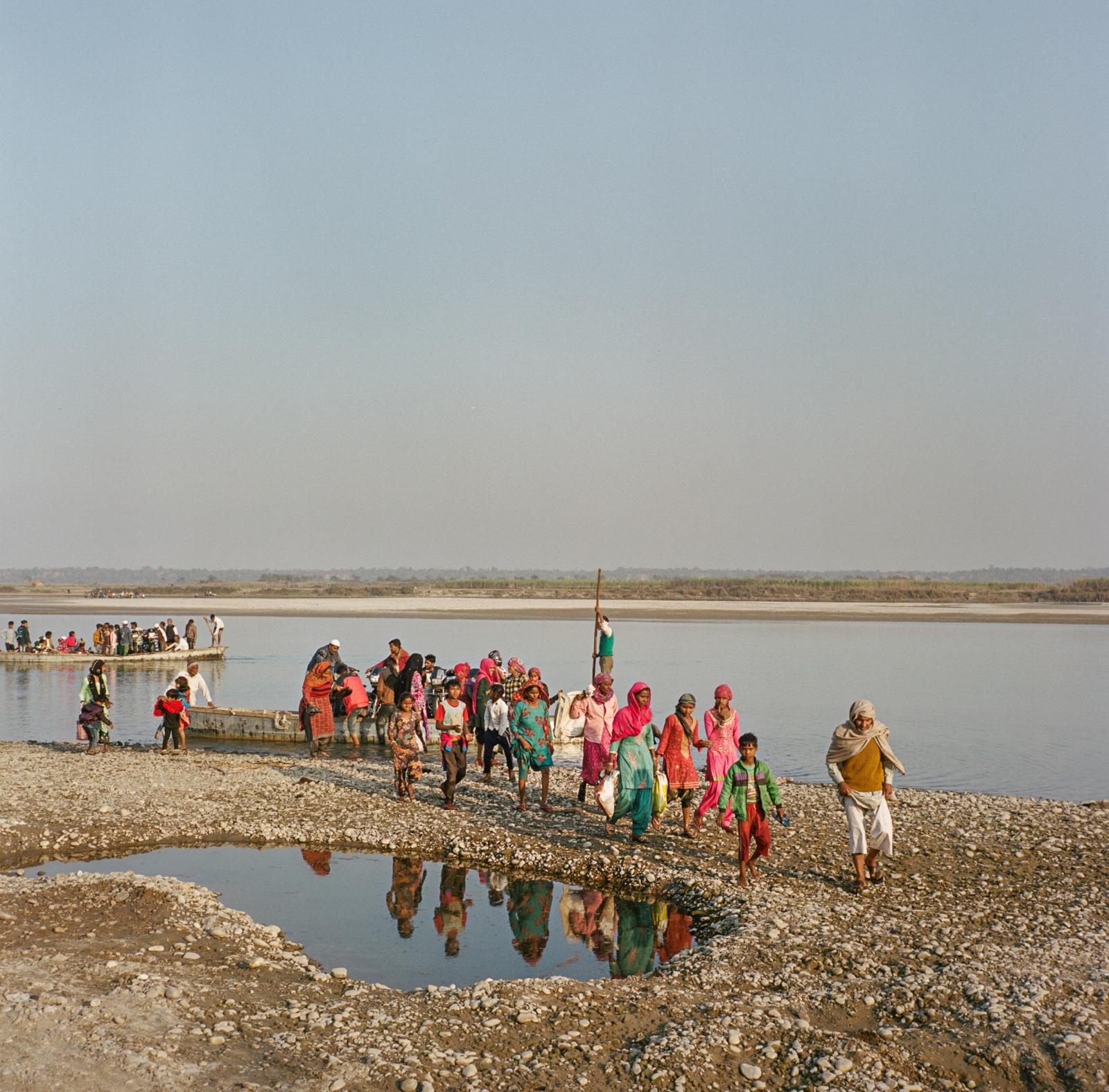 Saving India's Holiest River? - People wait to cross the Ganges river from the state of...