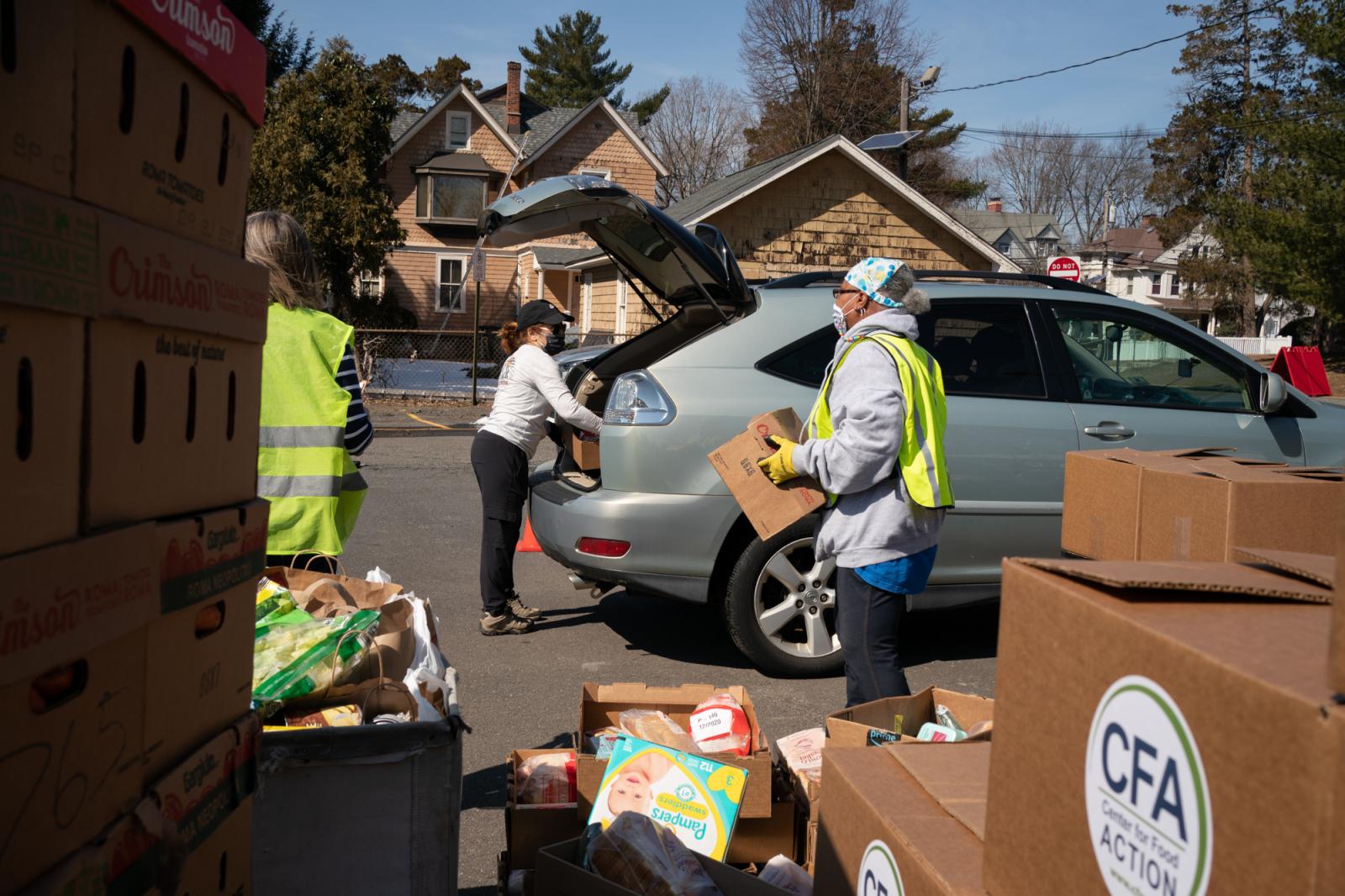 Volunteers load food packages i...nglewood, NJ, on March 9, 2021.